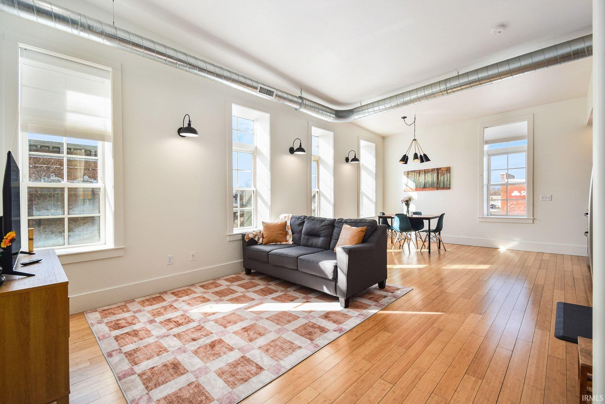 Image 2: Living area featuring light wood-style flooring, Living Room
