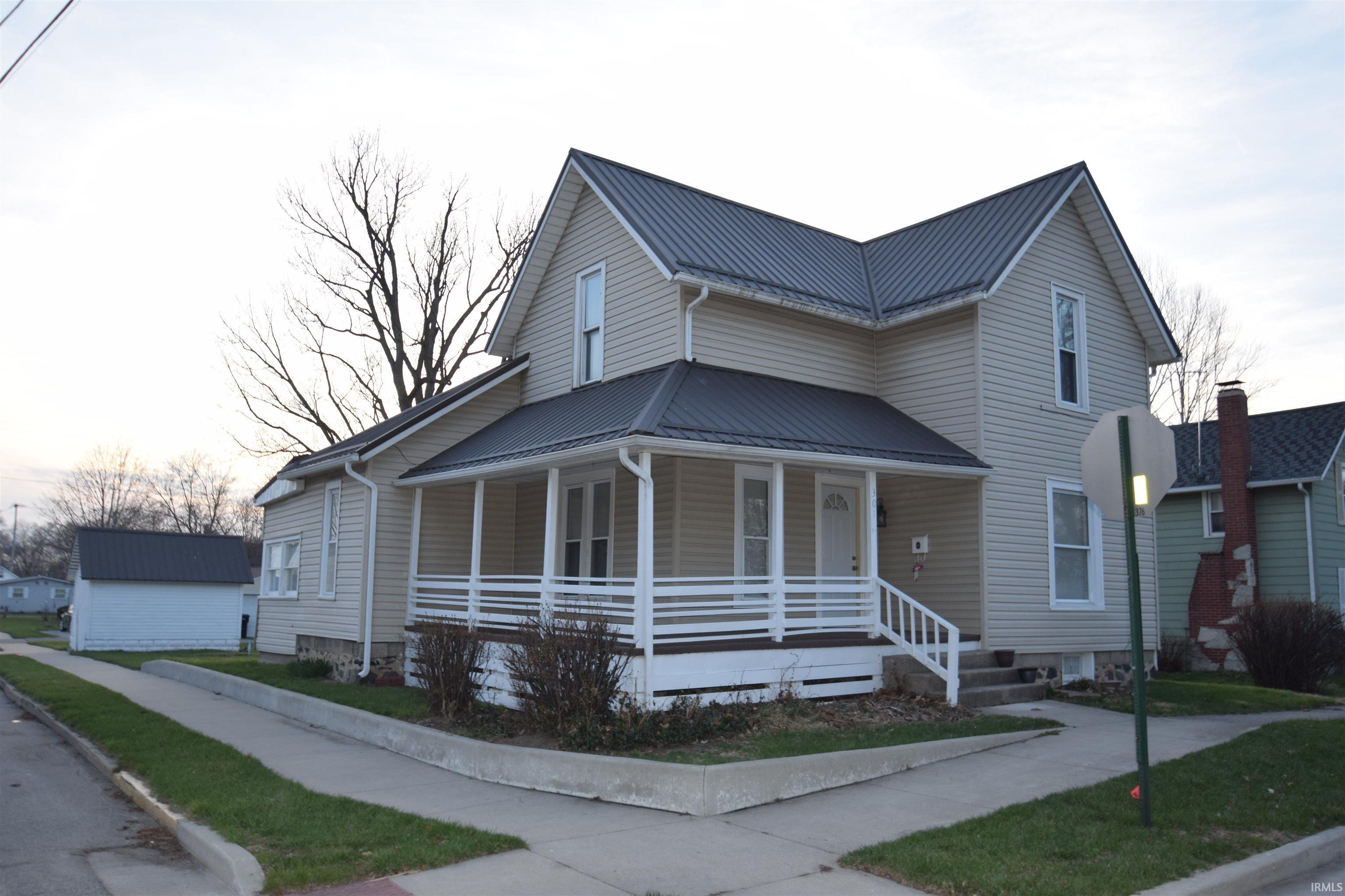 Image 0: View of front of home with covered porch and a metal roof, Front Of Structure