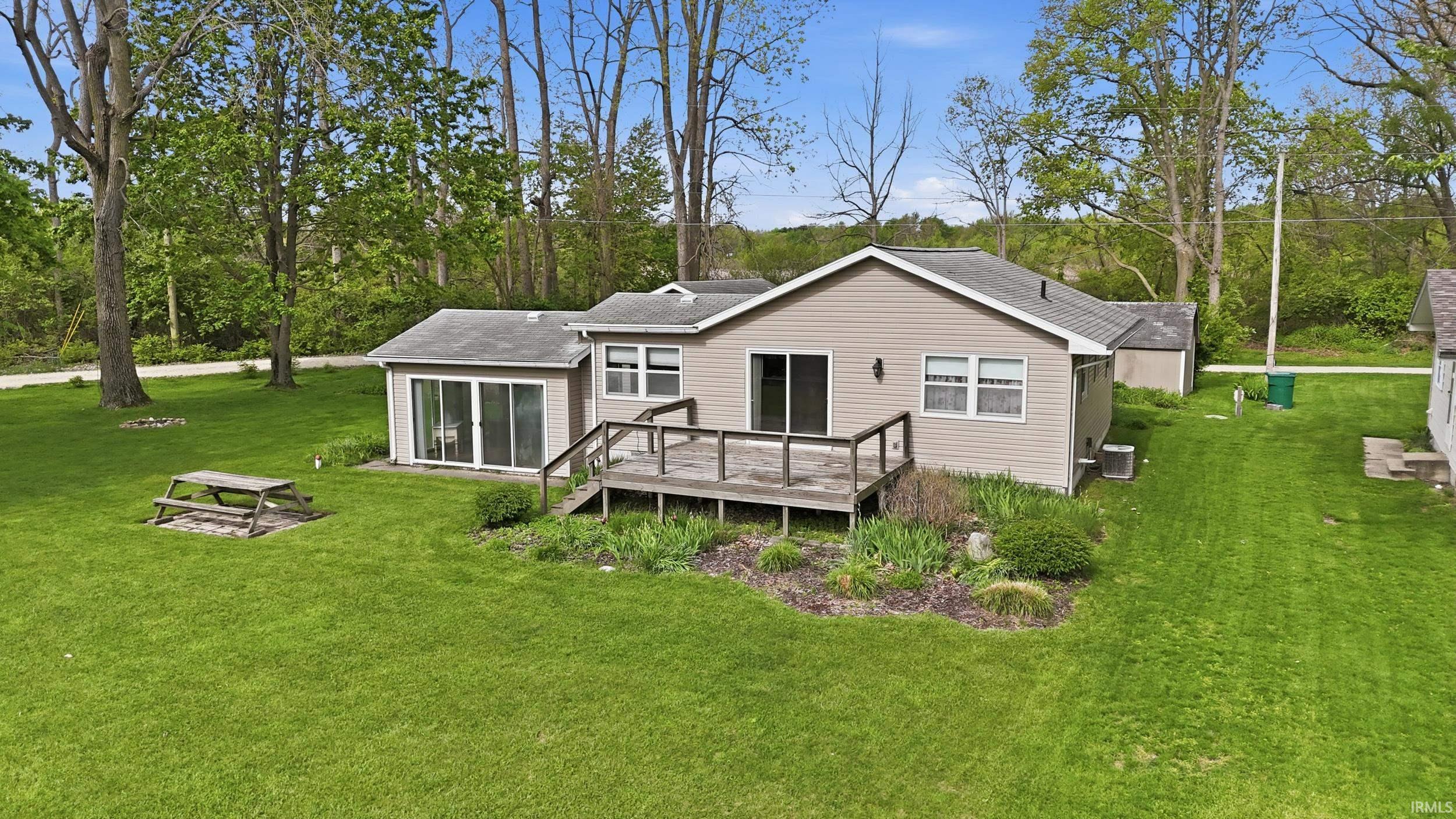 Image 2: Ranch-style residence featuring neutral siding and a pitched roof, Back Of Structure Image 2: Ranch-style residence featuring neutral siding and a pitched roof, Back Of Structure