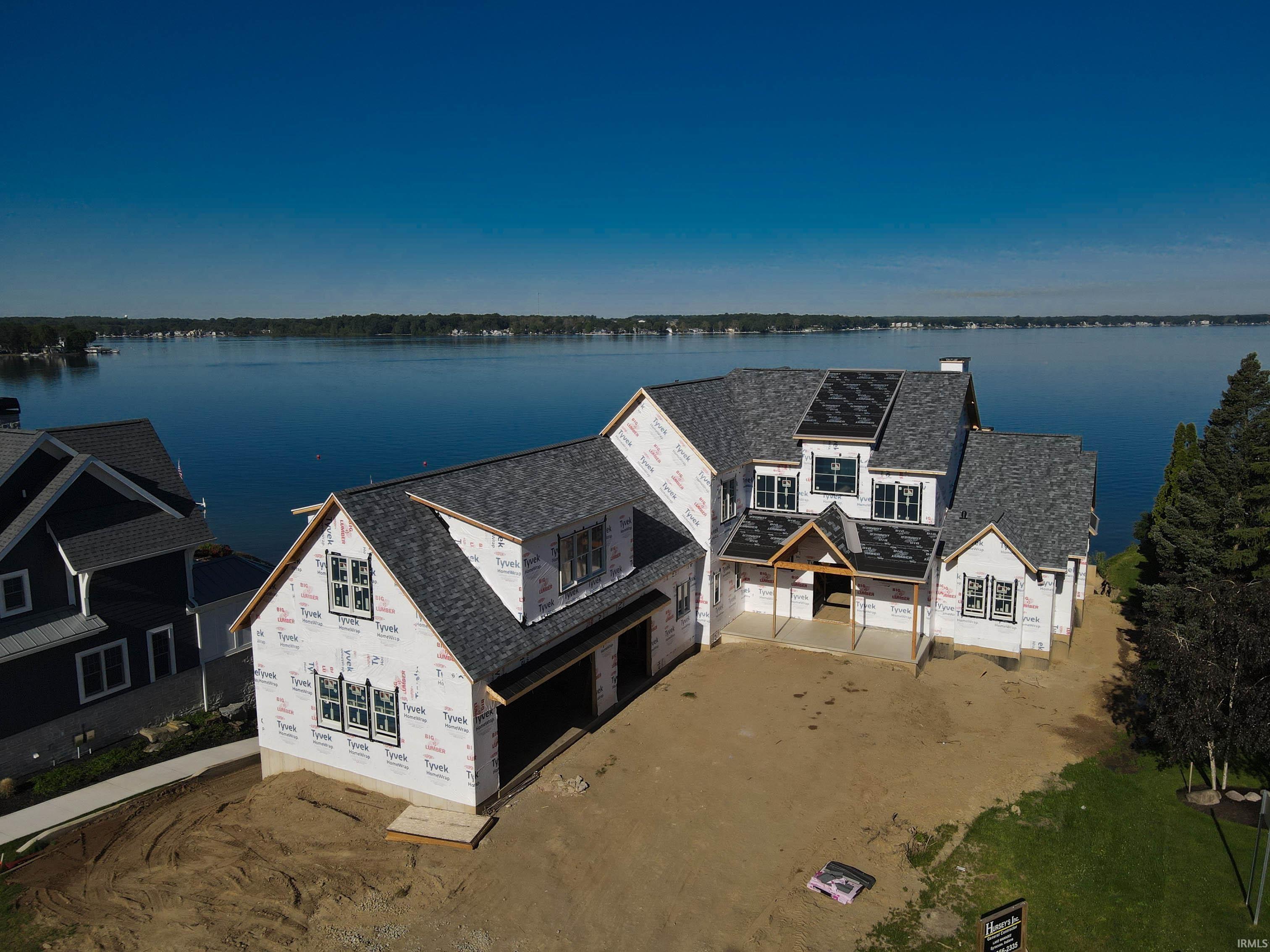 Image 1: Waterfront new construction with a multi-level asphalt shingle roof, Aerial View