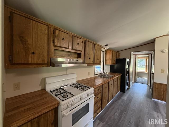 Image 2: Kitchen featuring extensive wood-finish cabinetry, wood-finish countertops, and a white gas range, Kitchen Image 2: Kitchen featuring extensive wood-finish cabinetry, wood-finish countertops, and a white gas range, Kitchen