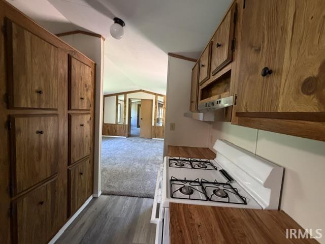 Image 3: Galley kitchen featuring wood-finish cabinetry, white gas range, and wood-finish countertops, Kitchen Image 3: Galley kitchen featuring wood-finish cabinetry, white gas range, and wood-finish countertops, Kitchen