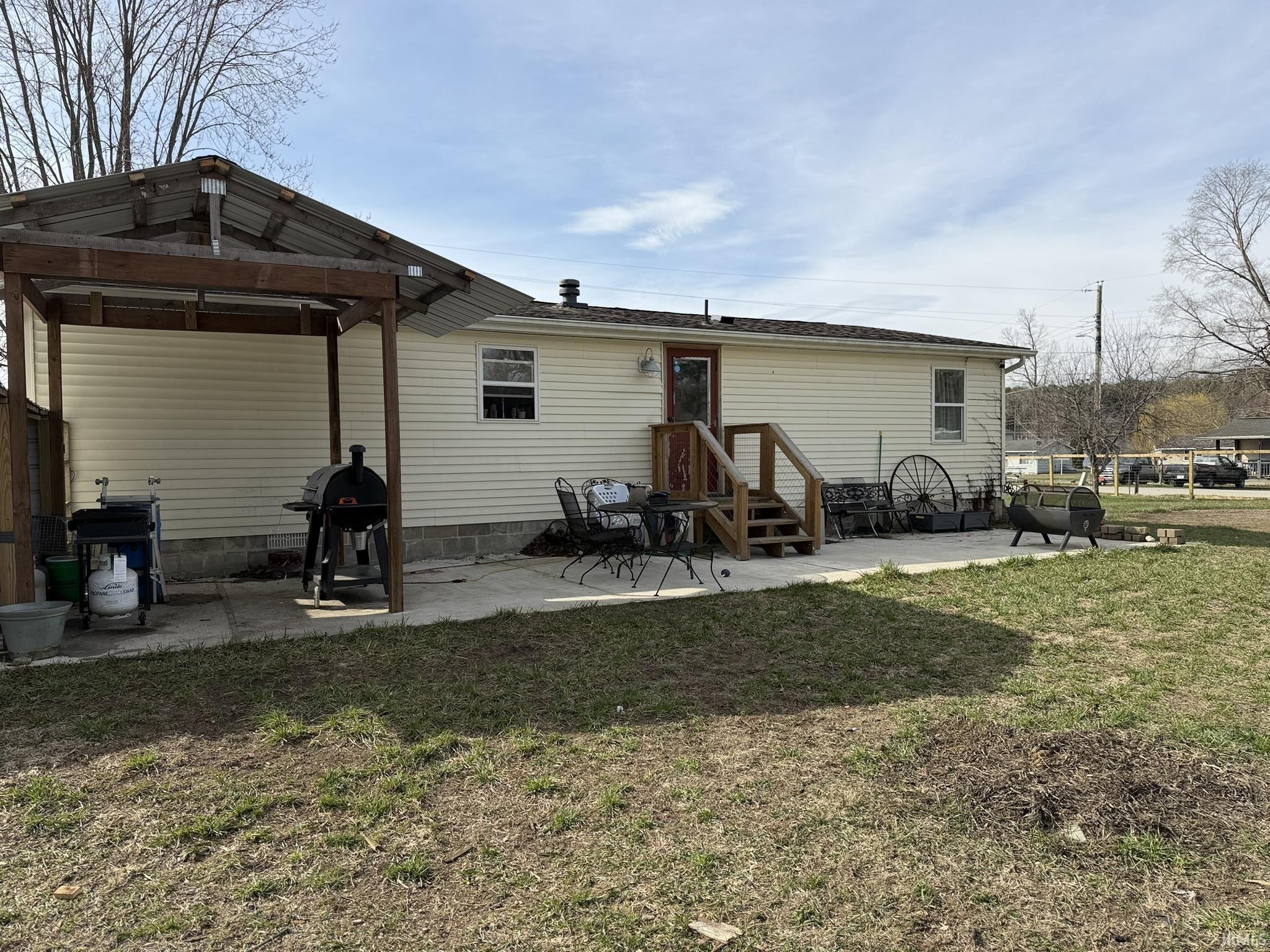 Image 2: Back of property featuring a patio area and a yard, Back Of Structure Image 2: Back of property featuring a patio area and a yard, Back Of Structure