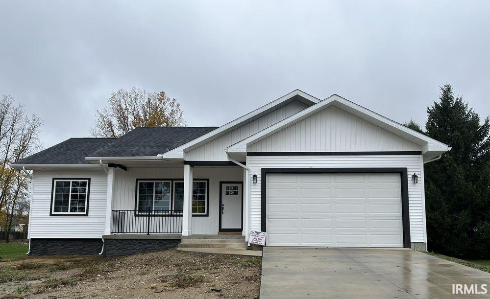 Image 1: Ranch-style house featuring covered porch, an attached garage, concrete driveway, and a shingled roof, Front Of Structure