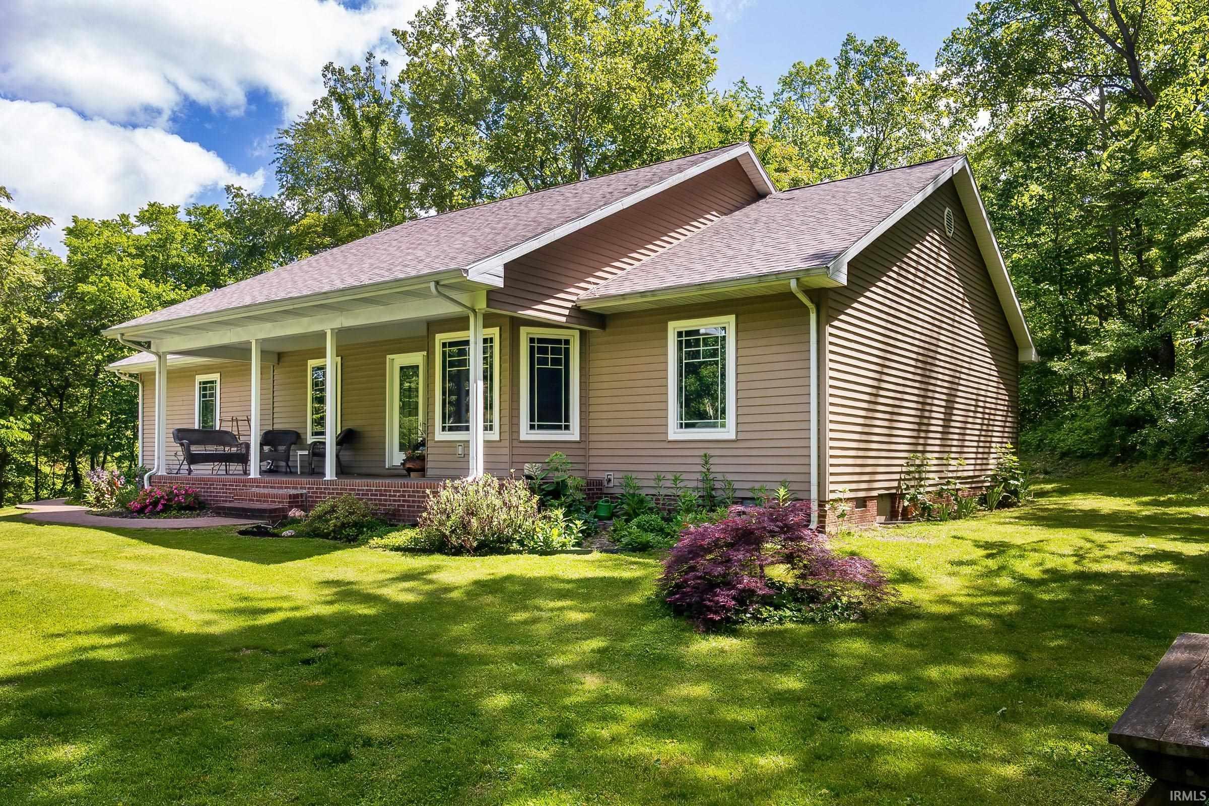 Image 1: Ranch-style residence featuring a covered front porch with white columns, light brown siding, white window trim, and a shingled roof, Front Of Structure Image 1: Ranch-style residence featuring a covered front porch with white columns, light brown siding, white window trim, and a shingled roof, Front Of Structure