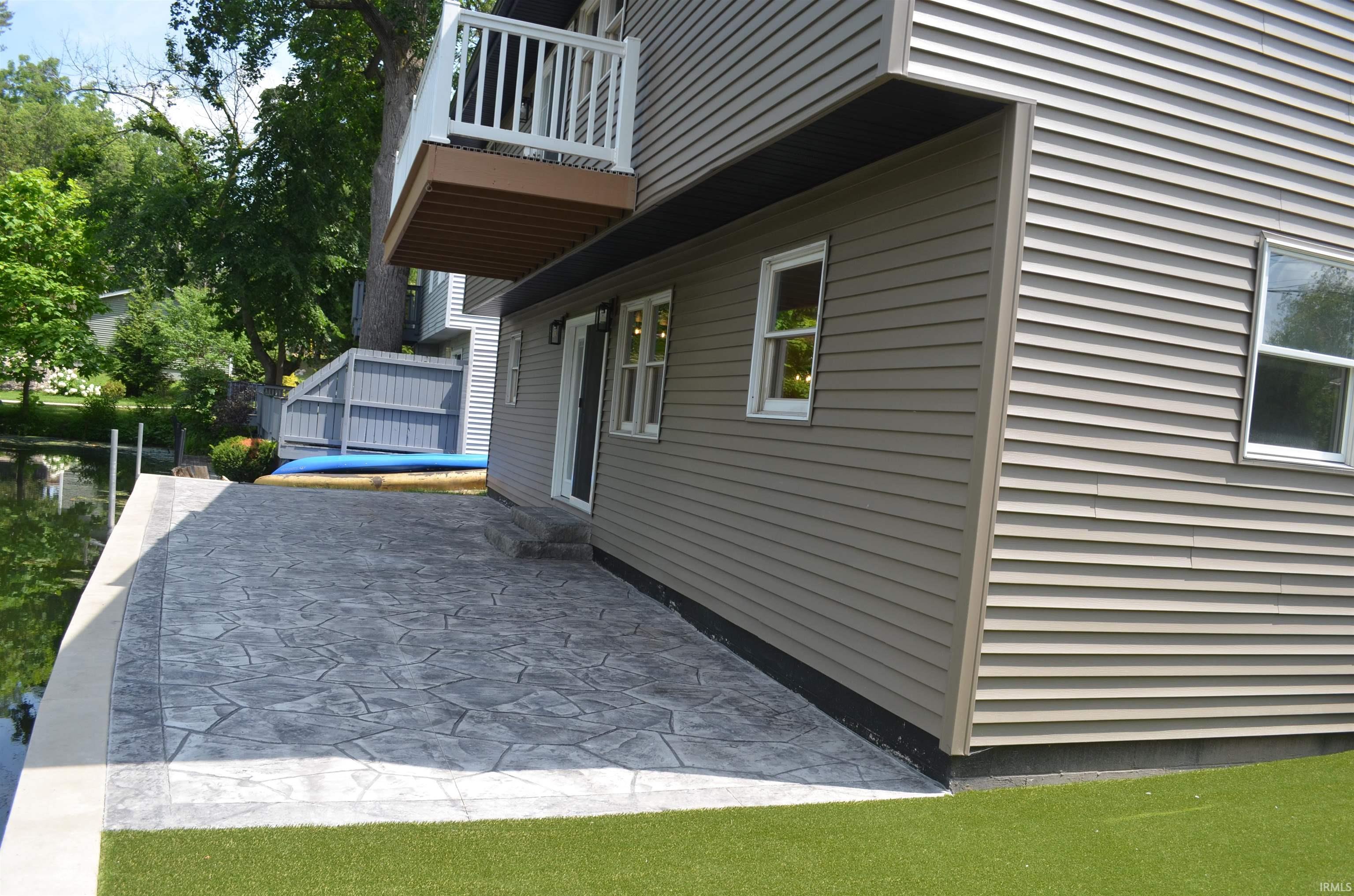 Image 2: Waterfront patio with stamped concrete, offering direct water access, Side Of Structure Image 2: Waterfront patio with stamped concrete, offering direct water access, Side Of Structure