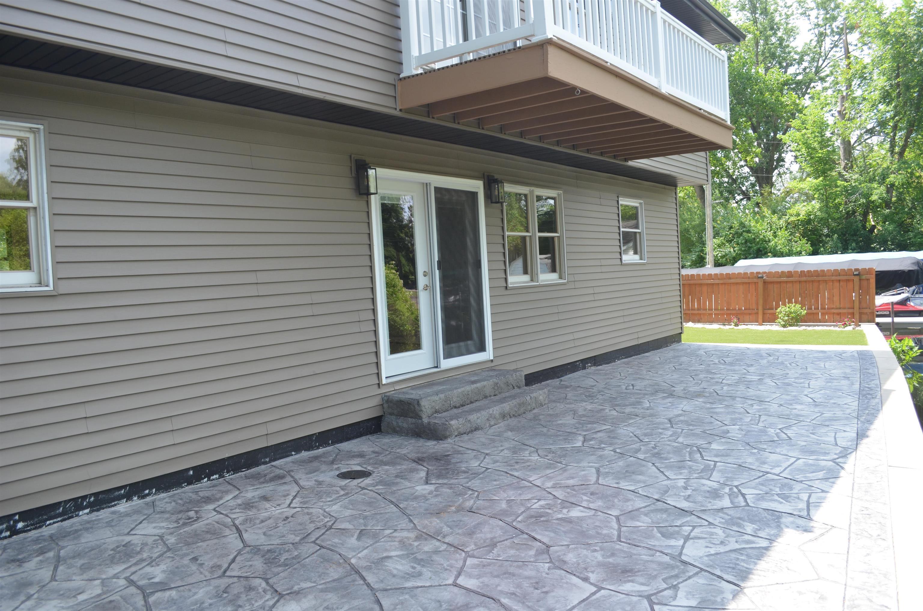 Image 3: Expansive stamped concrete patio with direct access via glass French doors, Patio Image 3: Expansive stamped concrete patio with direct access via glass French doors, Patio