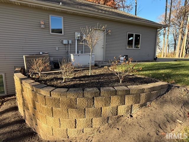 Image 1: Rear view of property featuring a yard and home generator, generator