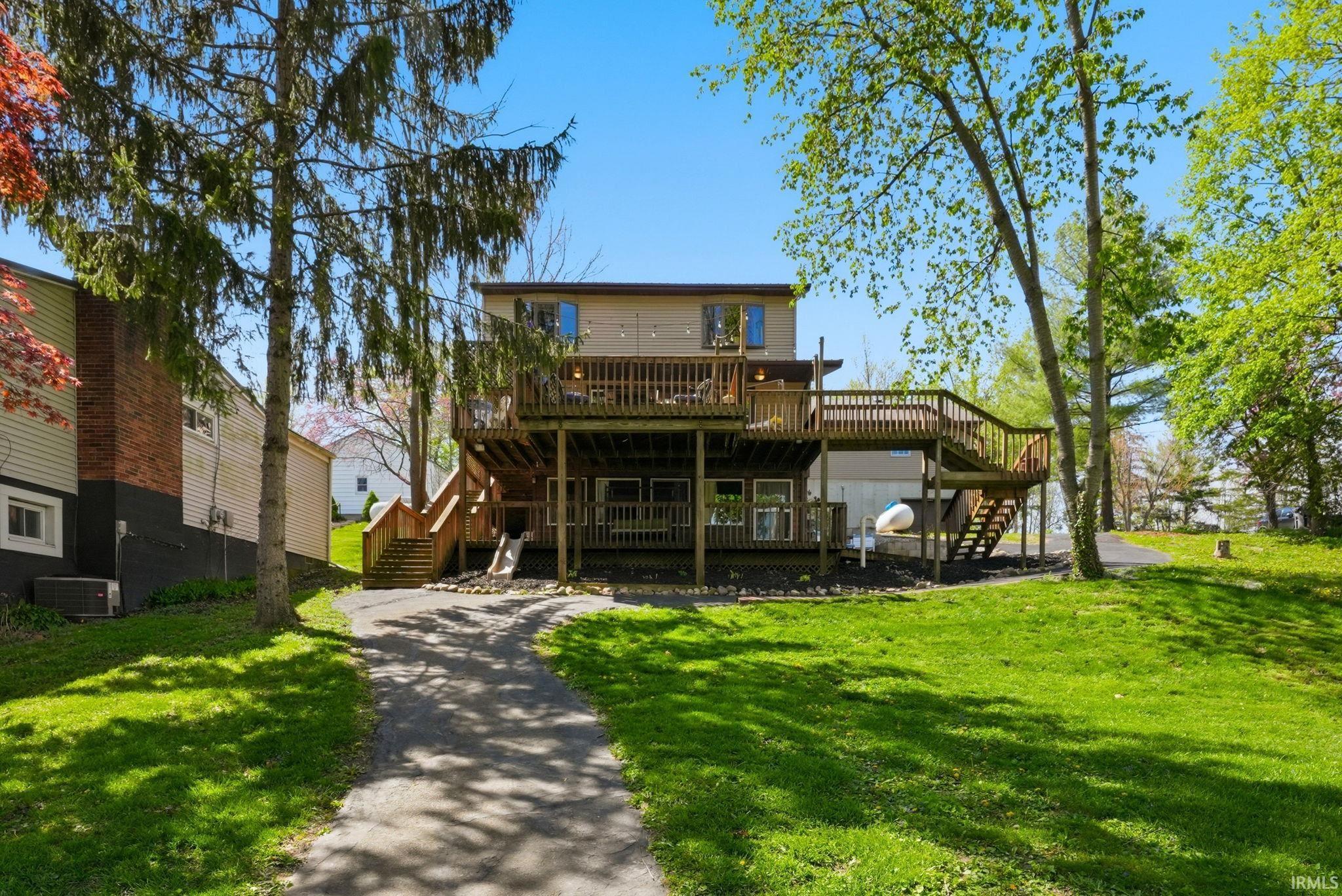 Image 0: Multi-level wood deck with integrated staircase, Back Of Structure