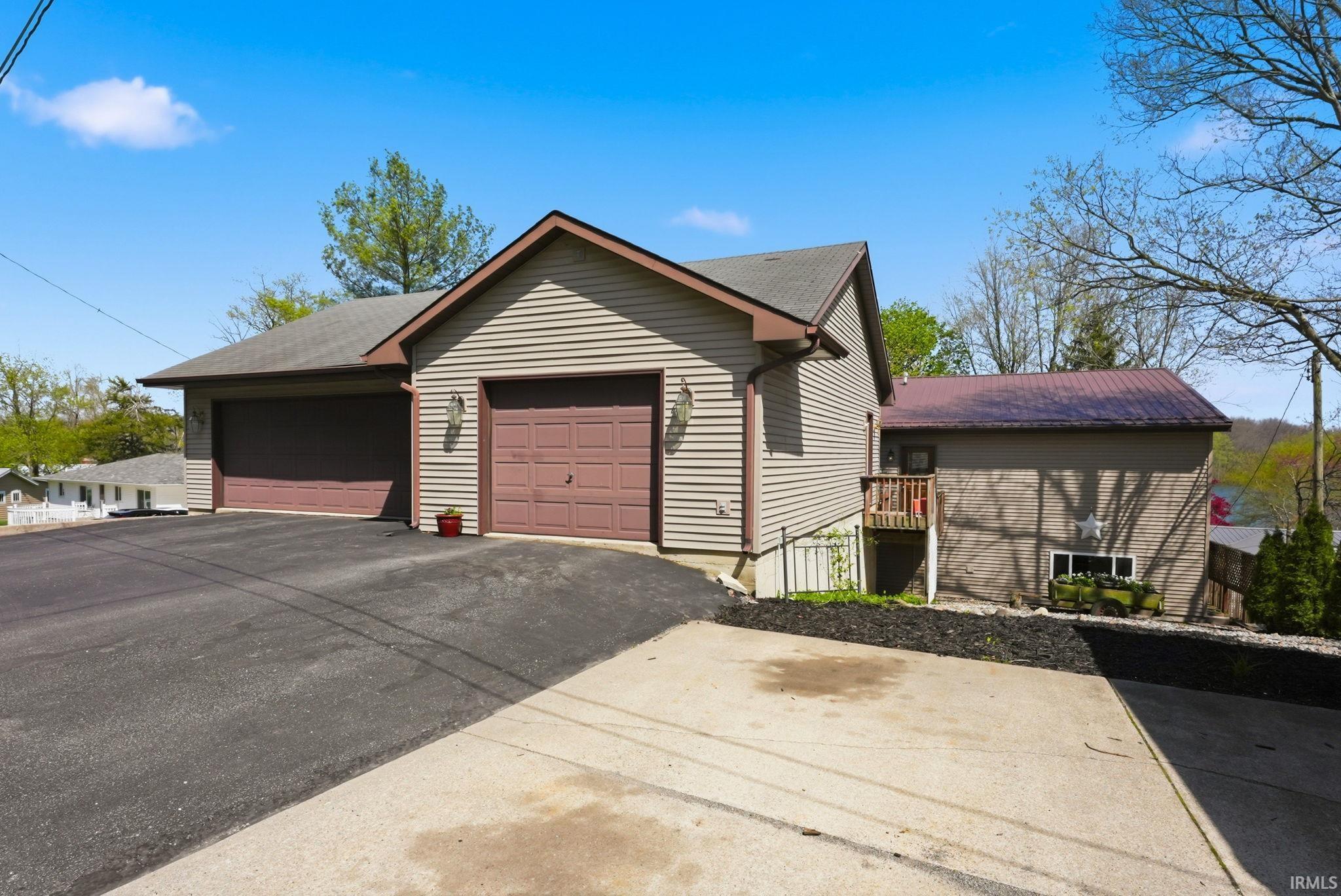 Image 1: Multiple garages featuring automatic doors and exterior lighting, Front Of Structure