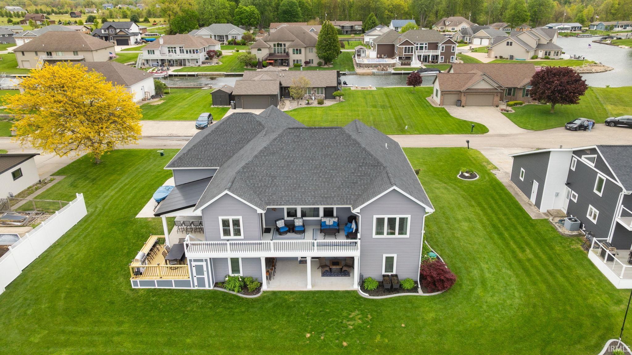 Image 3: Two-story residence featuring gray siding and a dark shingle roof, Aerial View