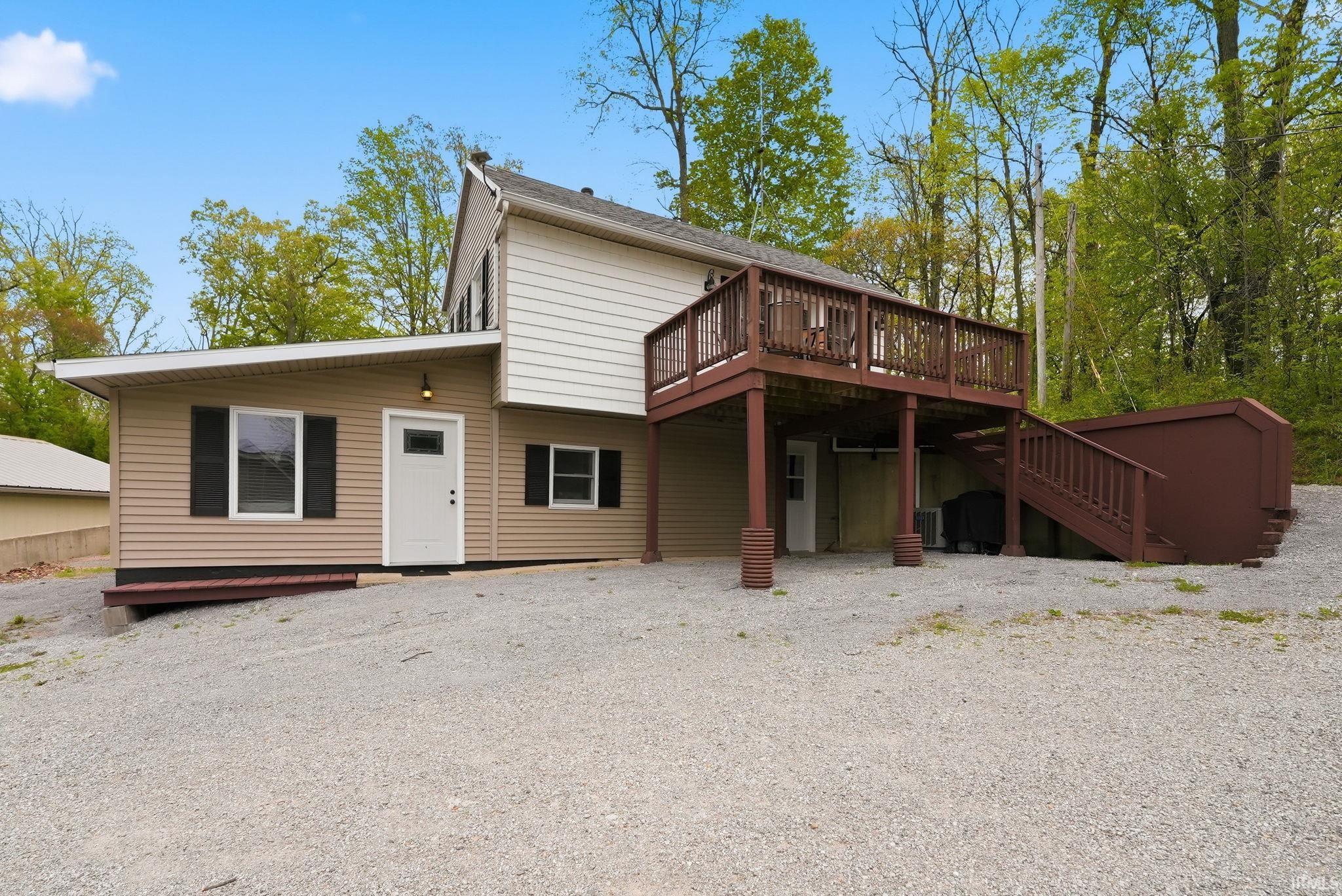 Image 0: Multi-level exterior featuring tan and white siding, Back Of Structure Image 0: Multi-level exterior featuring tan and white siding, Back Of Structure
