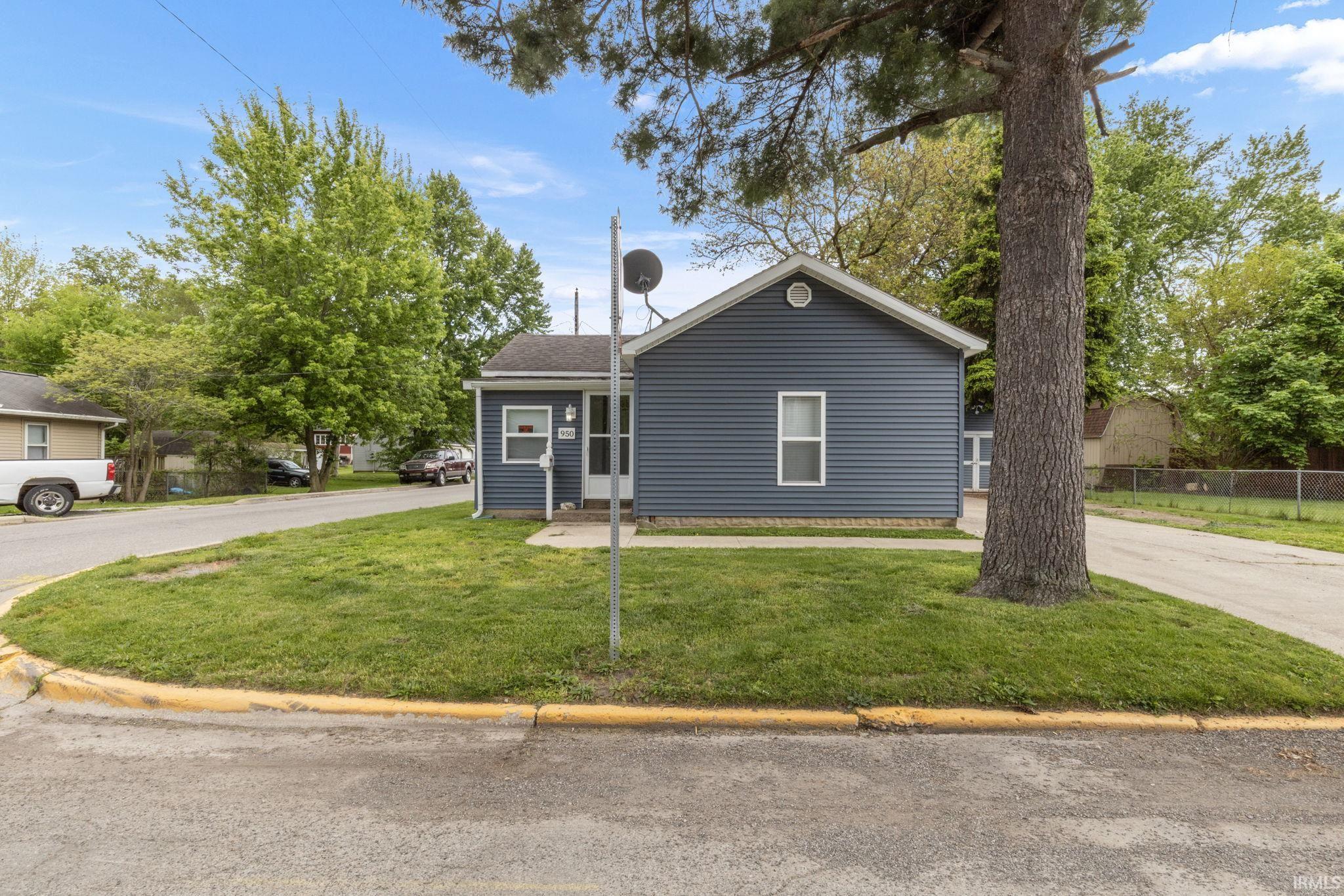Image 0: Single-story property featuring blue horizontal siding and white trim, Front Of Structure