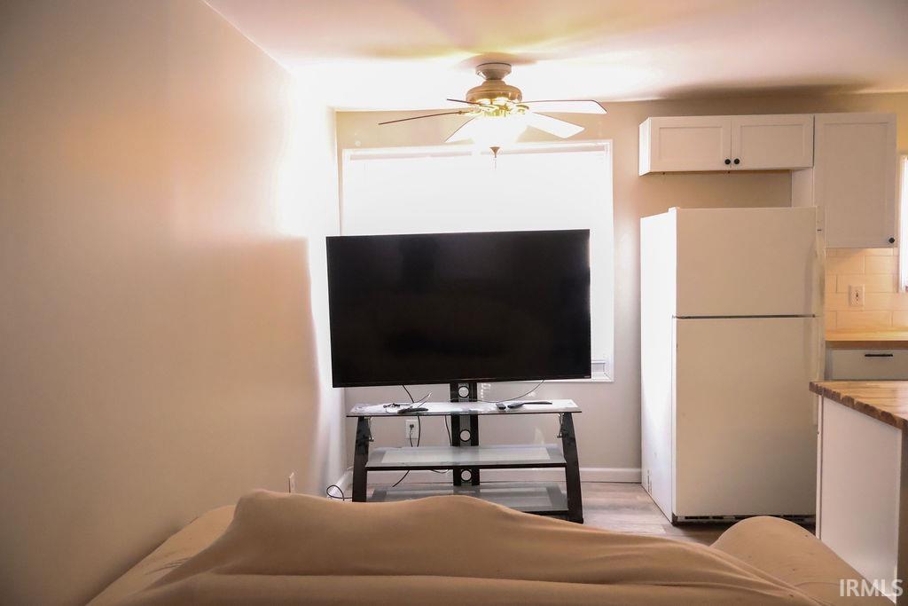 Image 1: Living room with ceiling fan and light wood-style flooring, Living Room