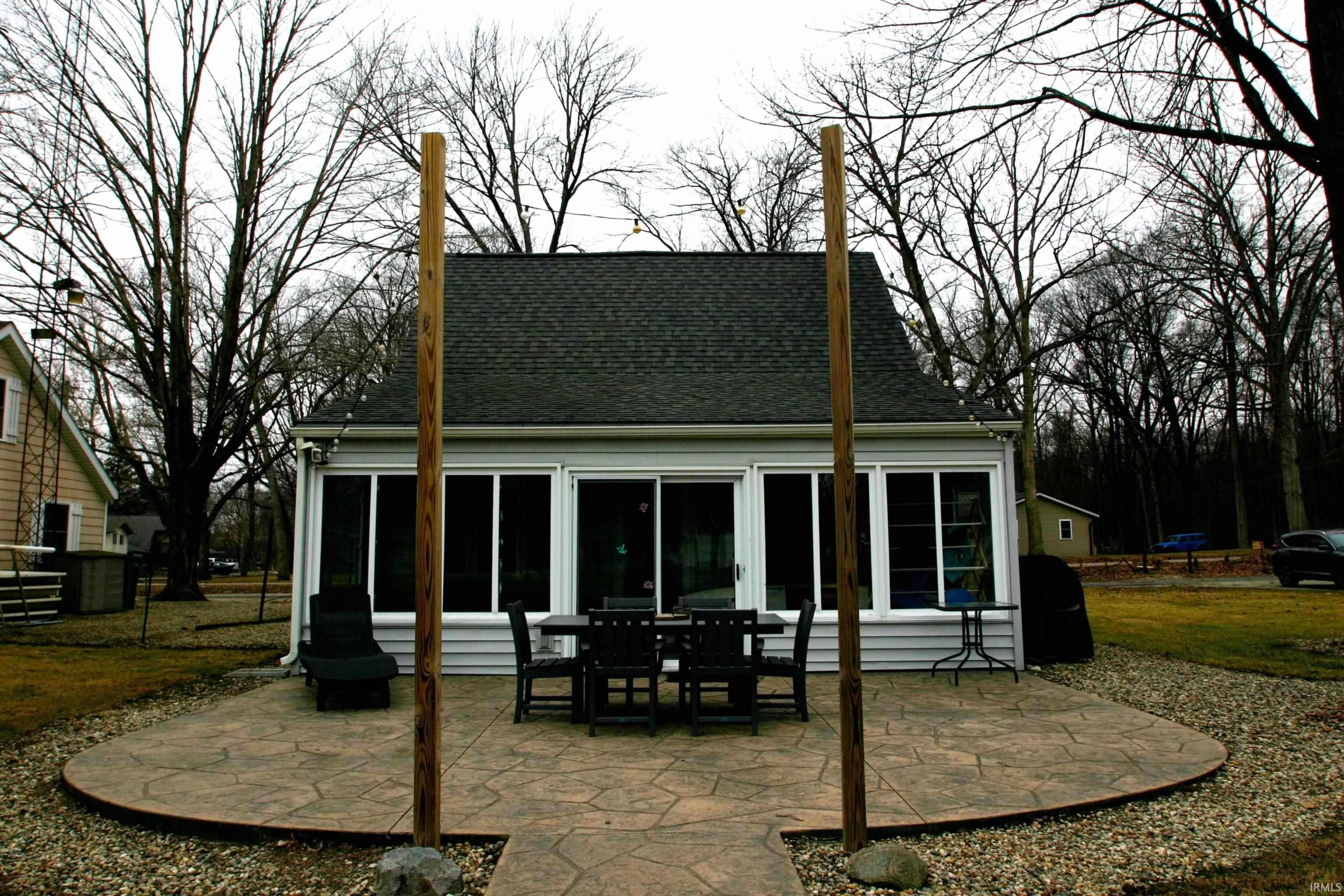 Image 3: View of the back of the home that has a view of the canal and down to the main lake. This is a very nice 23x17 stamped concrete patio. Plenty of room for outdoor entertaining and relaxation., Backyard Patio
