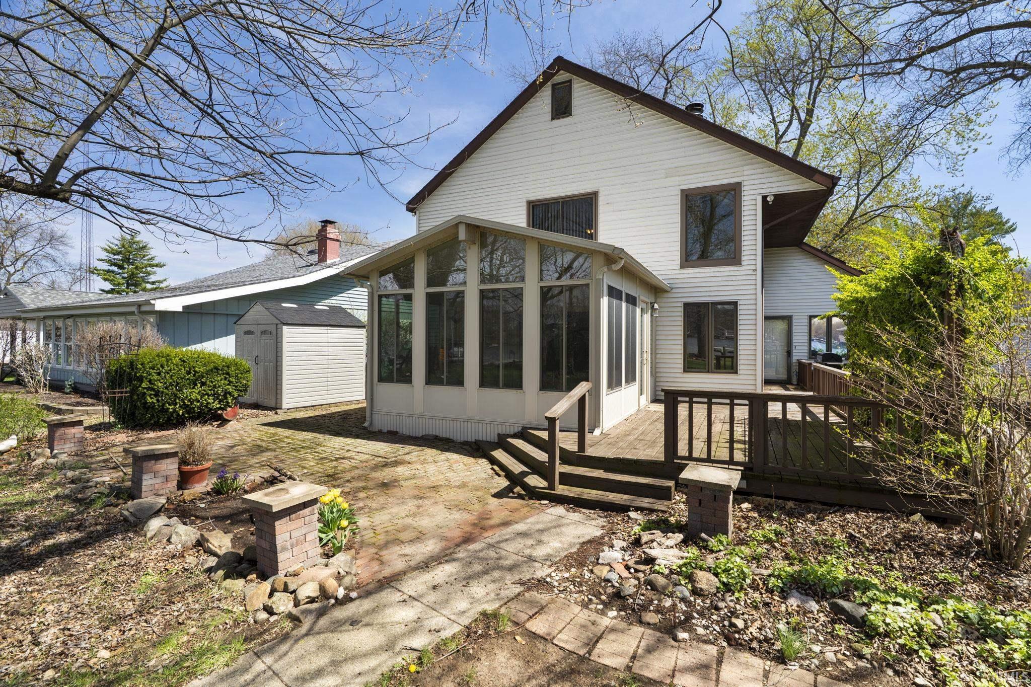 Image 0: Back of house with a sunroom, a storage shed, and a deck, Back Of Structure