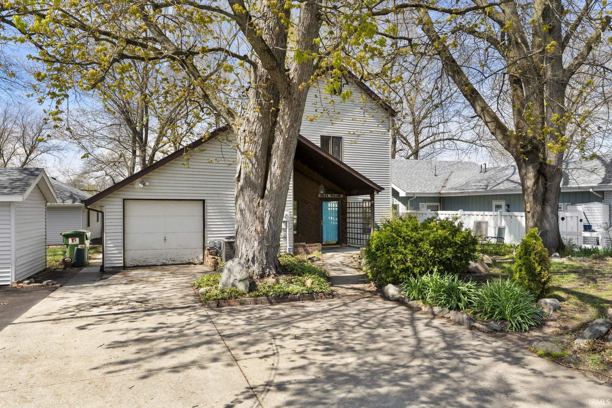 Image 3: View of front of house with concrete driveway and a garage, Front Of Structure