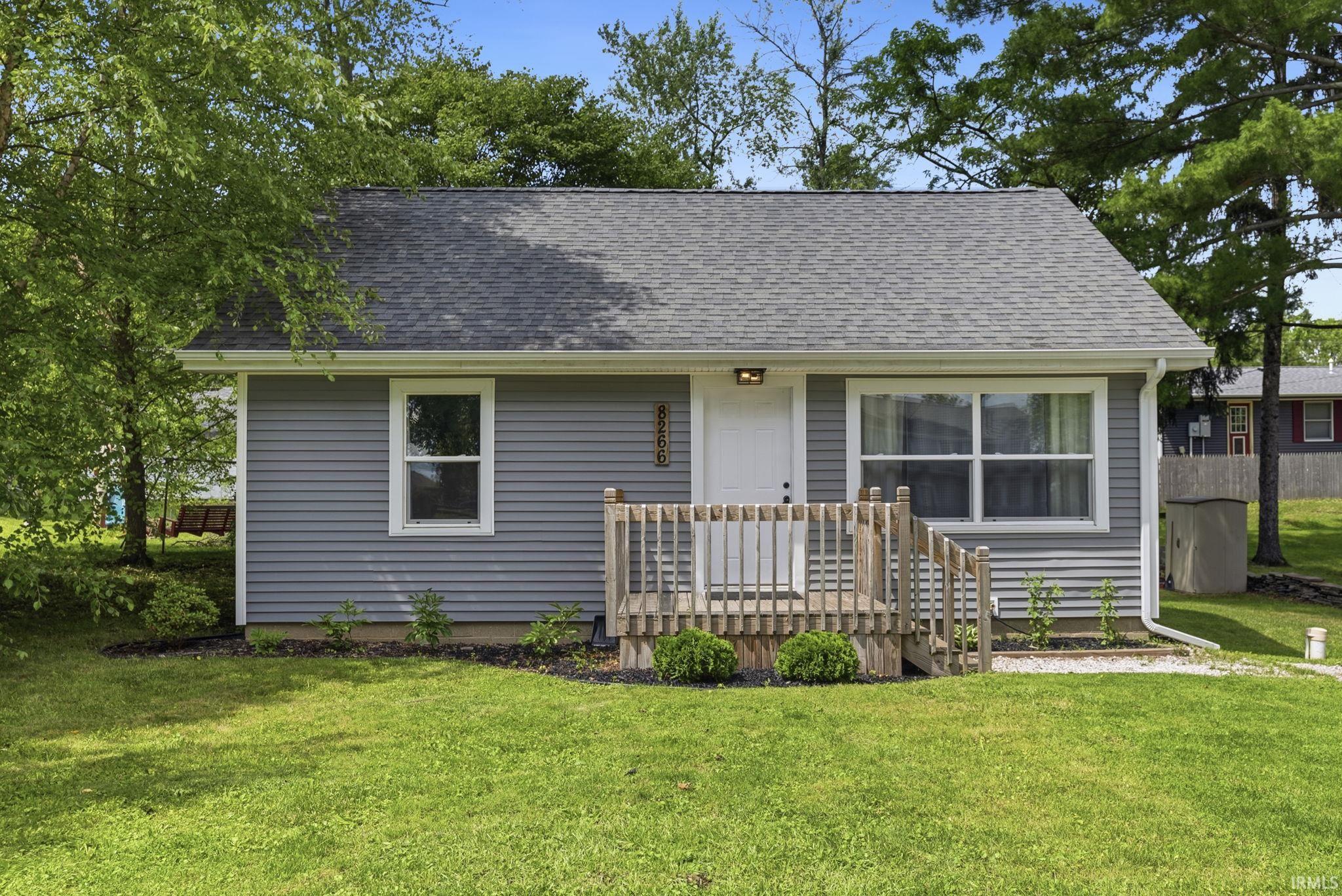 Image 1: Gray siding exterior with white trim, featuring a light gray shingle roof, Front Of Structure