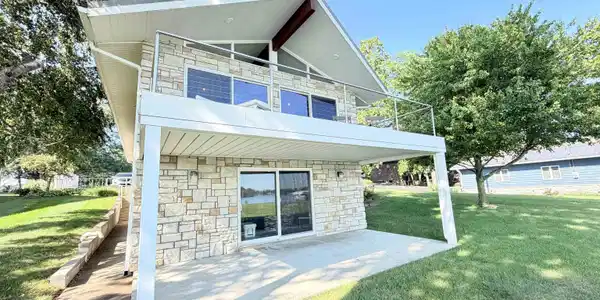 Image 1: Concrete driveway with ample parking, leading to a detached garage, Front Of Structure