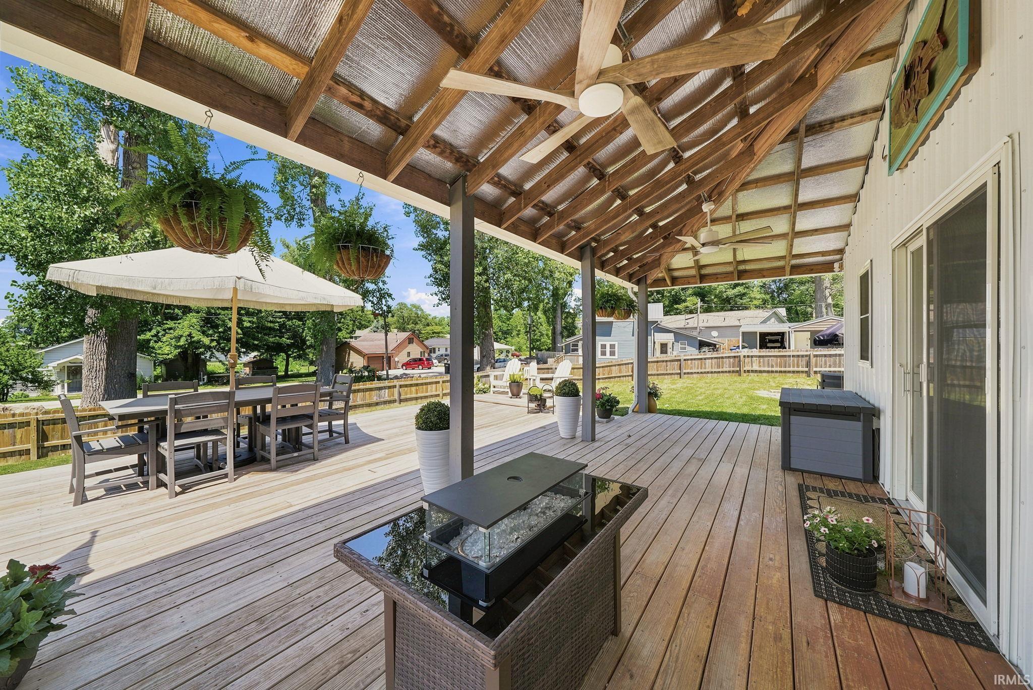 Image 3: Expansive wood deck with a partial vaulted wood ceiling, dual ceiling fans, and recessed lighting, Deck Image 3: Expansive wood deck with a partial vaulted wood ceiling, dual ceiling fans, and recessed lighting, Deck