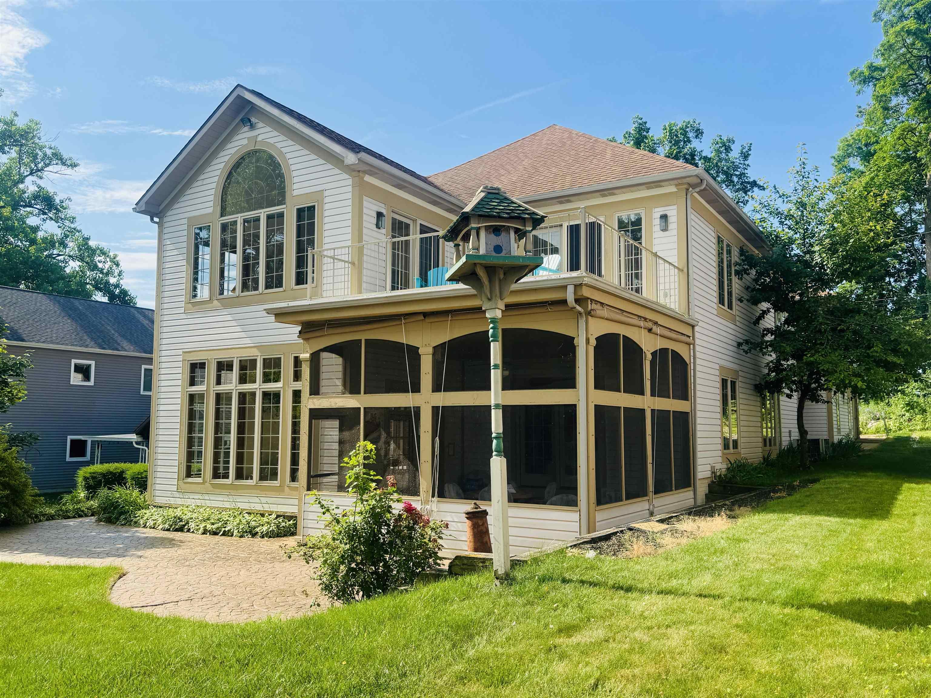 Image 2: Back of house featuring a sunroom, a yard, and a balcony, Lakeside of Home Image 2: Back of house featuring a sunroom, a yard, and a balcony, Lakeside of Home