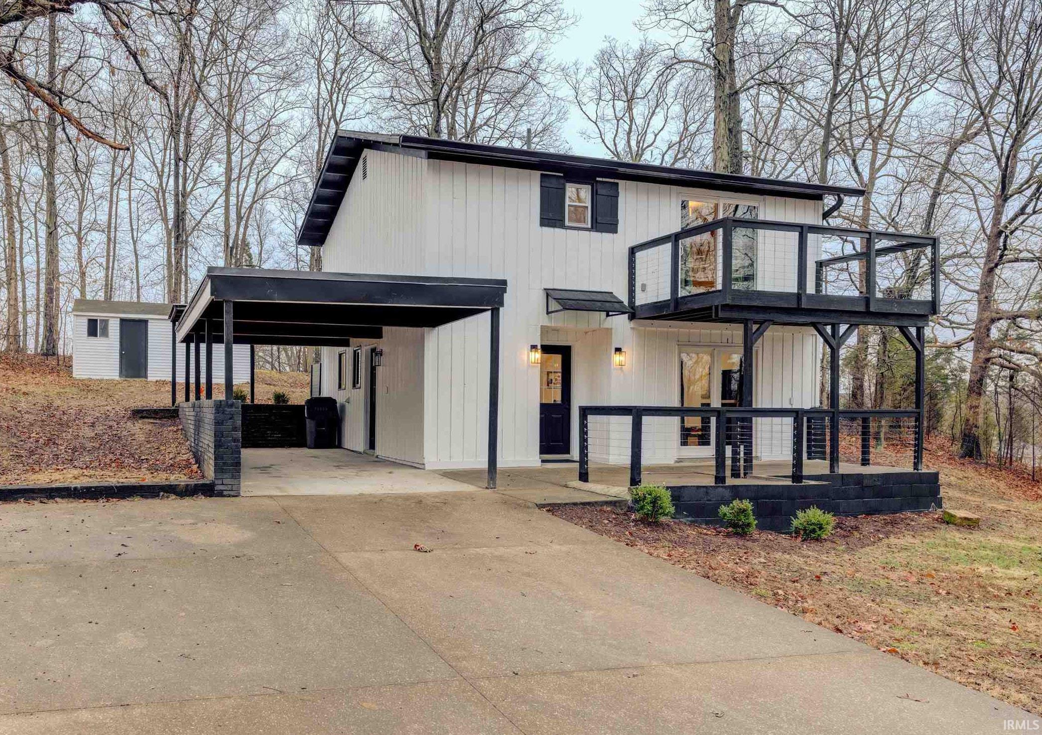 Image 0: Modern farmhouse style home with driveway, a carport, and a patio, Front Of Structure