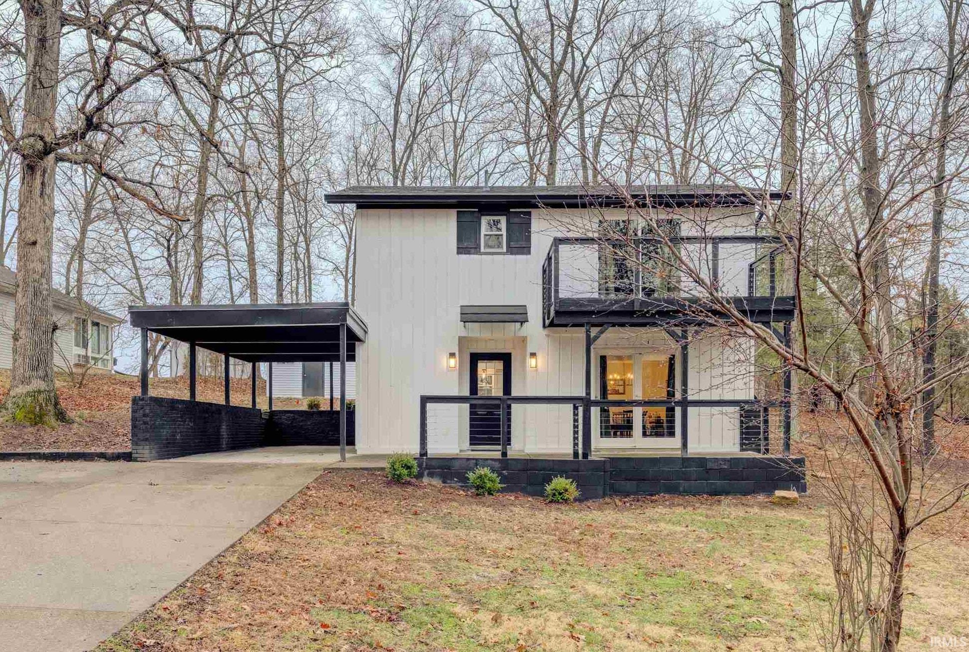 Image 1: View of front of property with a carport, a front yard, concrete driveway, and covered porch, Front Of Structure