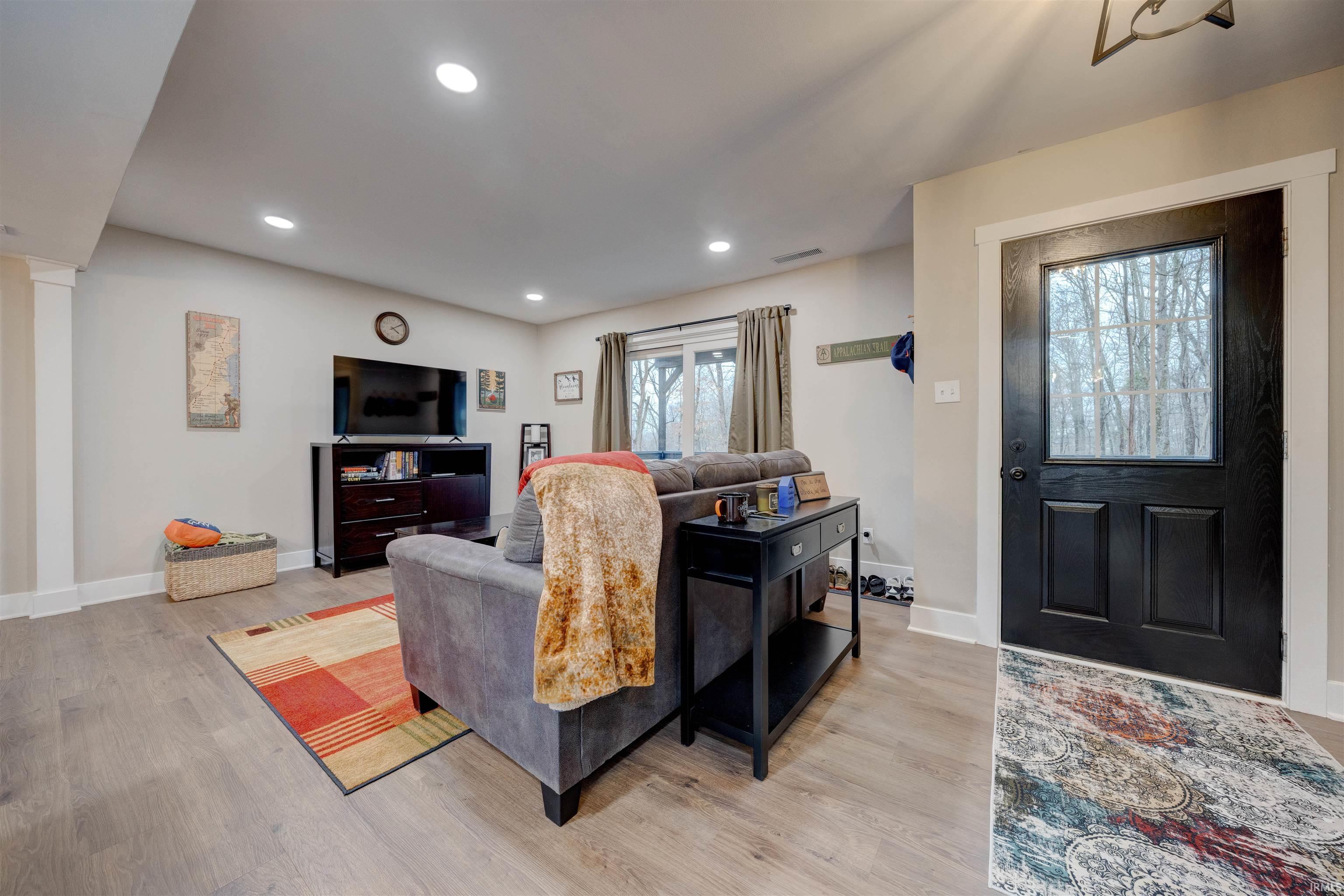 Image 2: Living room with light wood-style floors and recessed lighting, Living Room