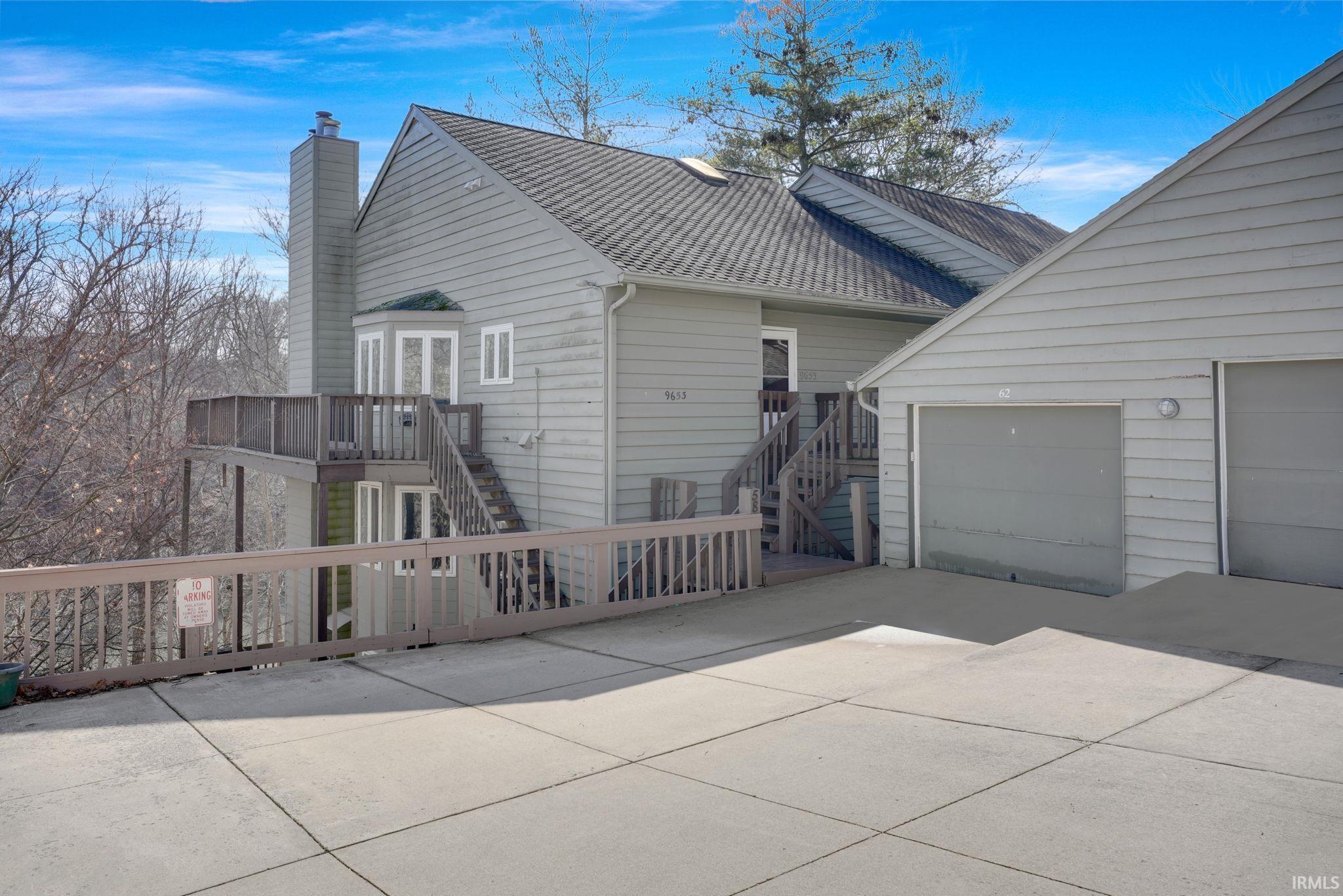 Image 0: View of side of property featuring a chimney, driveway, a garage, and roof with shingles, Side Of Structure Image 0: View of side of property featuring a chimney, driveway, a garage, and roof with shingles, Side Of Structure