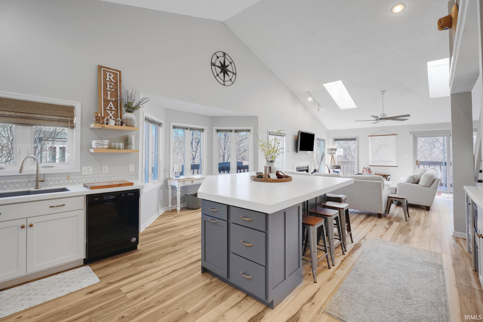 Image 2: Kitchen with vaulted ceiling, a skylight, black dishwasher, open floor plan, and a kitchen breakfast bar, Kitchen Image 2: Kitchen with vaulted ceiling, a skylight, black dishwasher, open floor plan, and a kitchen breakfast bar, Kitchen