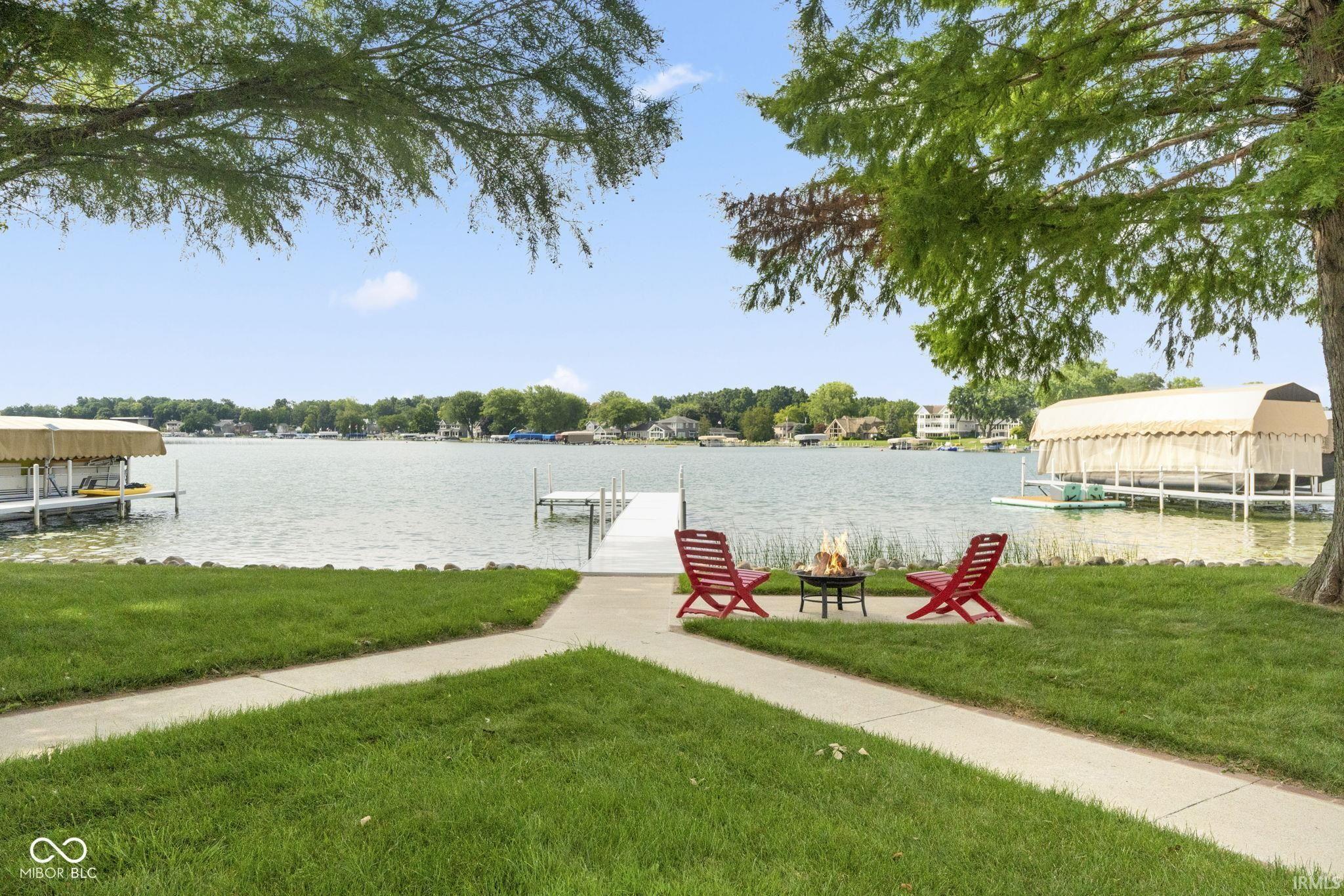Image 2: Dock with a lawn and a water view, Front Yard