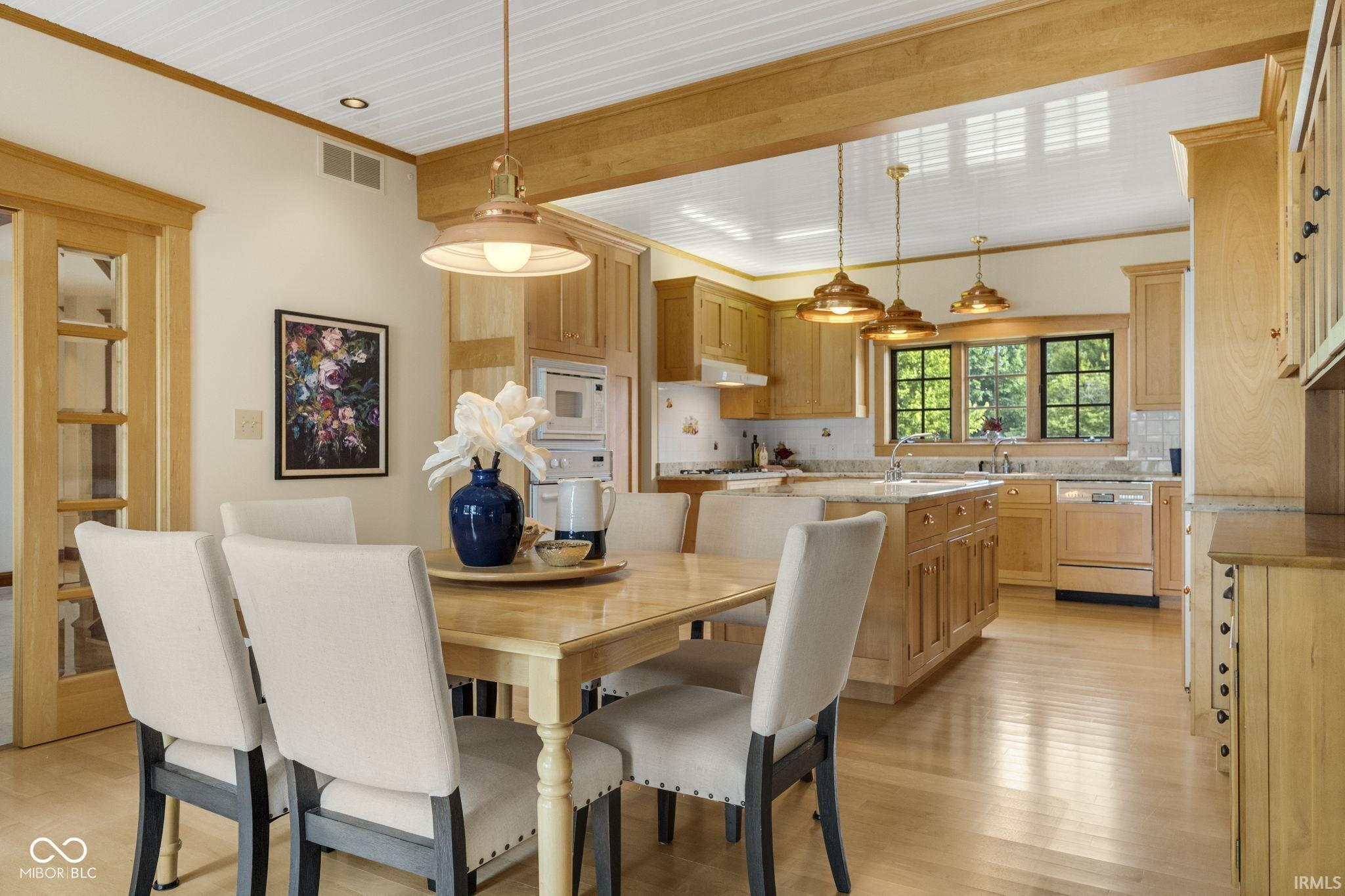 Image 3: Dining area featuring light wood finished floors and crown molding, Dining Area