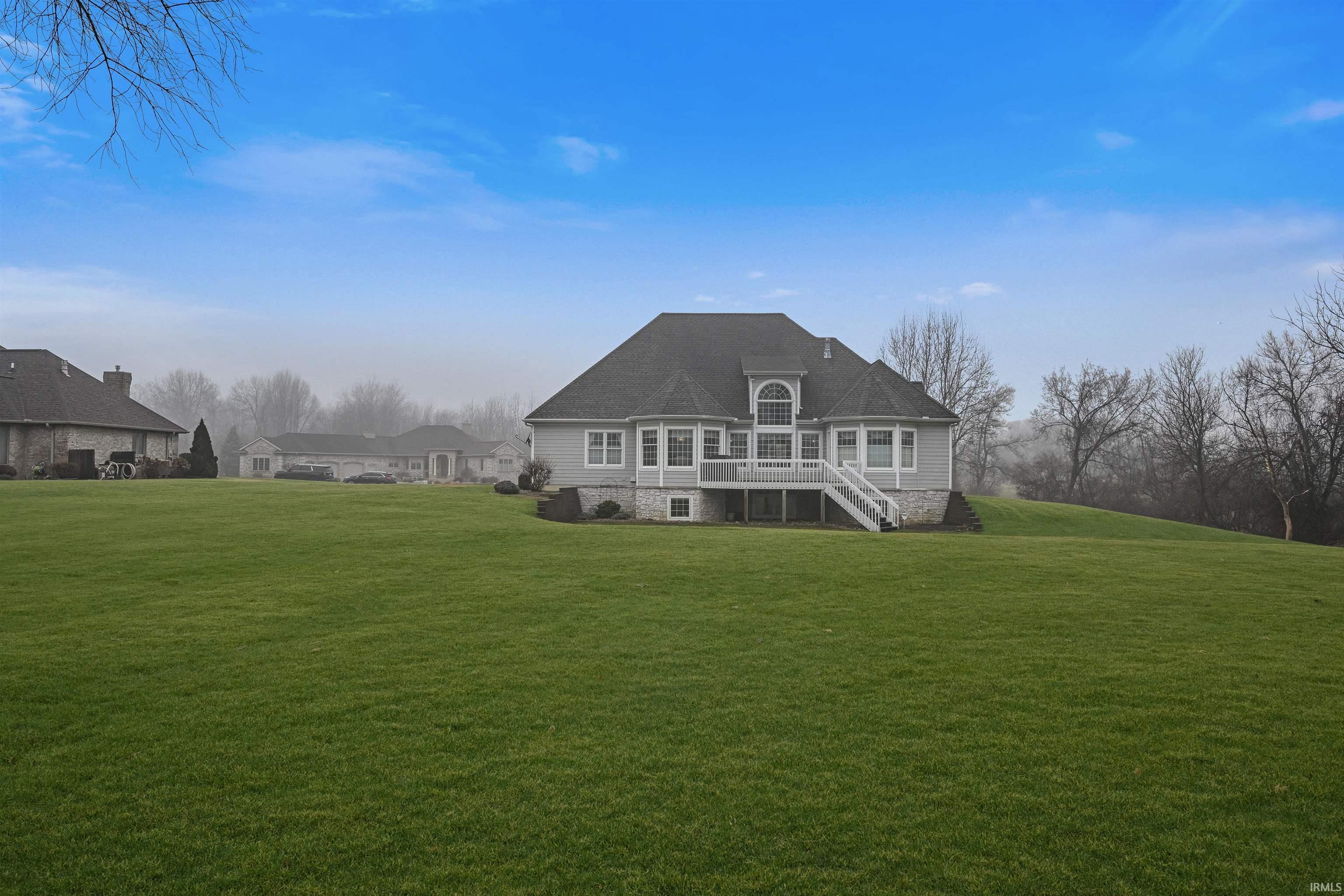 Image 2: Rear view of house featuring a lawn, a deck, and a shingled roof, Back Of Structure
