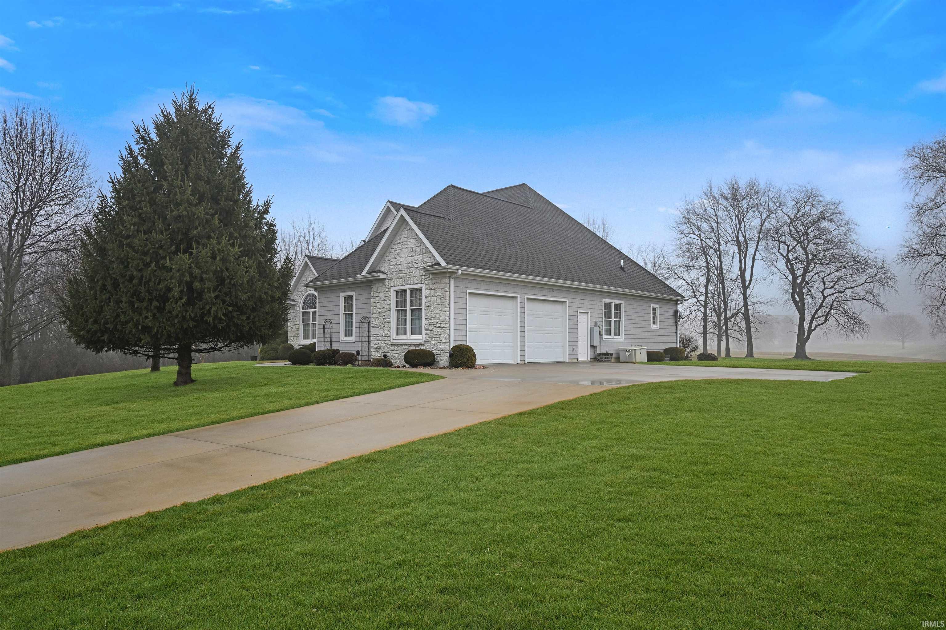 Image 3: View of front of house with a front yard, stone siding, concrete driveway, a garage, and a shingled roof, Front Of Structure