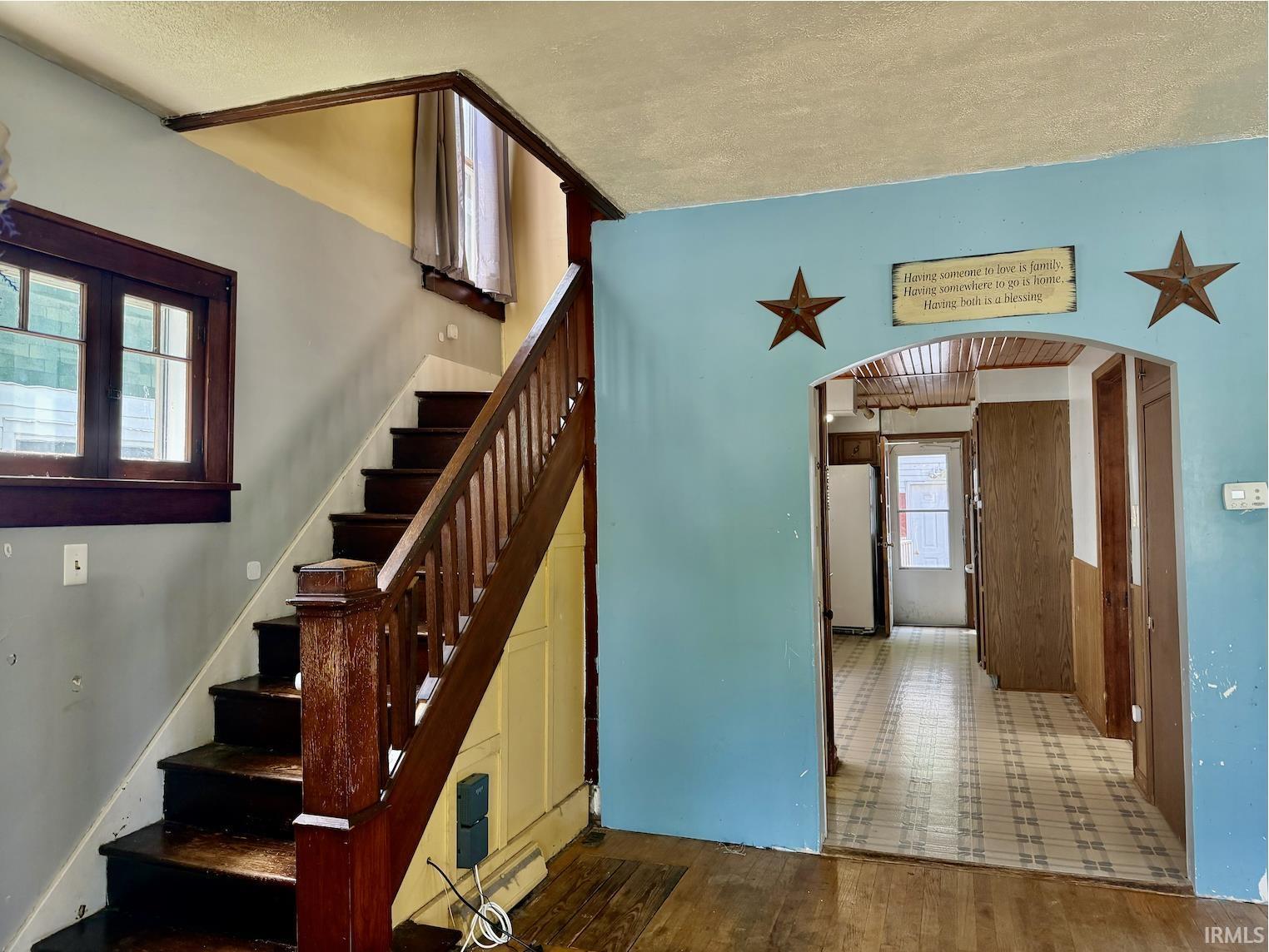 Image 2: Hardwood staircase featuring wood balusters and newel post, Stairs