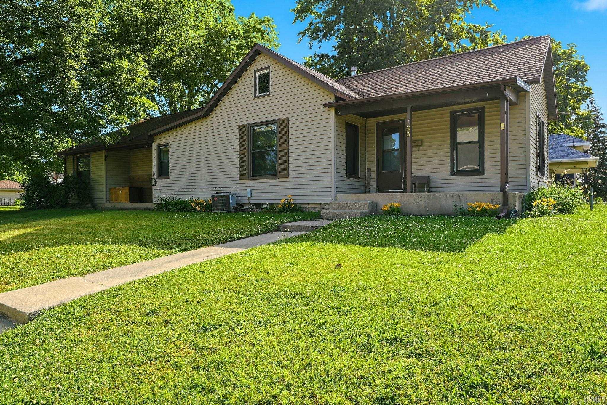 Image 0: Craftsman-style residence featuring light-toned siding, dark trim accents, and a covered front porch, Front Of Structure Image 0: Craftsman-style residence featuring light-toned siding, dark trim accents, and a covered front porch, Front Of Structure