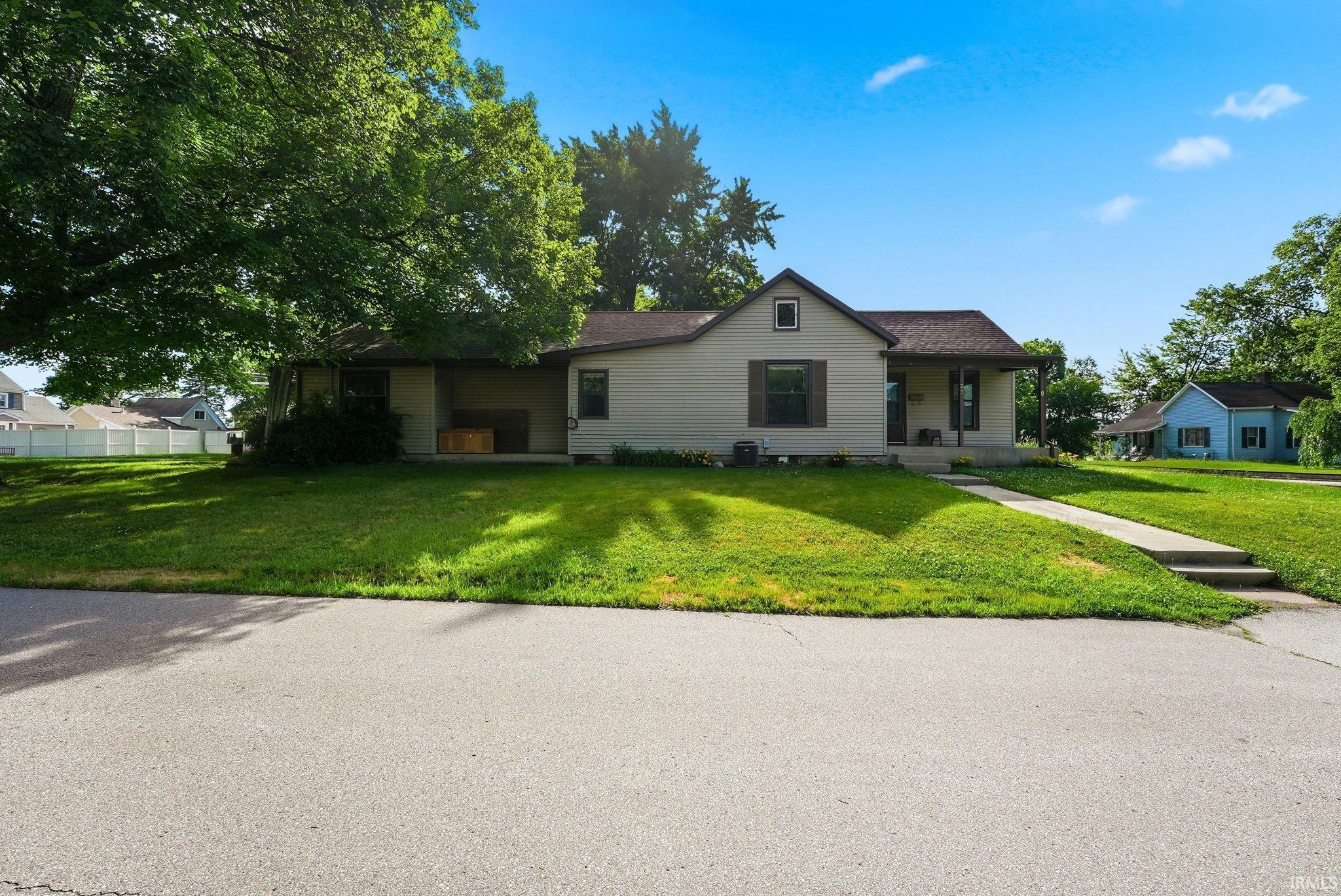 Image 2: Single-story residence featuring light-toned siding and a brown shingled roof, Front Of Structure Image 2: Single-story residence featuring light-toned siding and a brown shingled roof, Front Of Structure