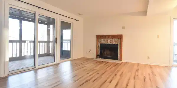 Image 2: Unfurnished living room with light wood finished floors and a tiled fireplace Image 2: Unfurnished living room with light wood finished floors and a tiled fireplace