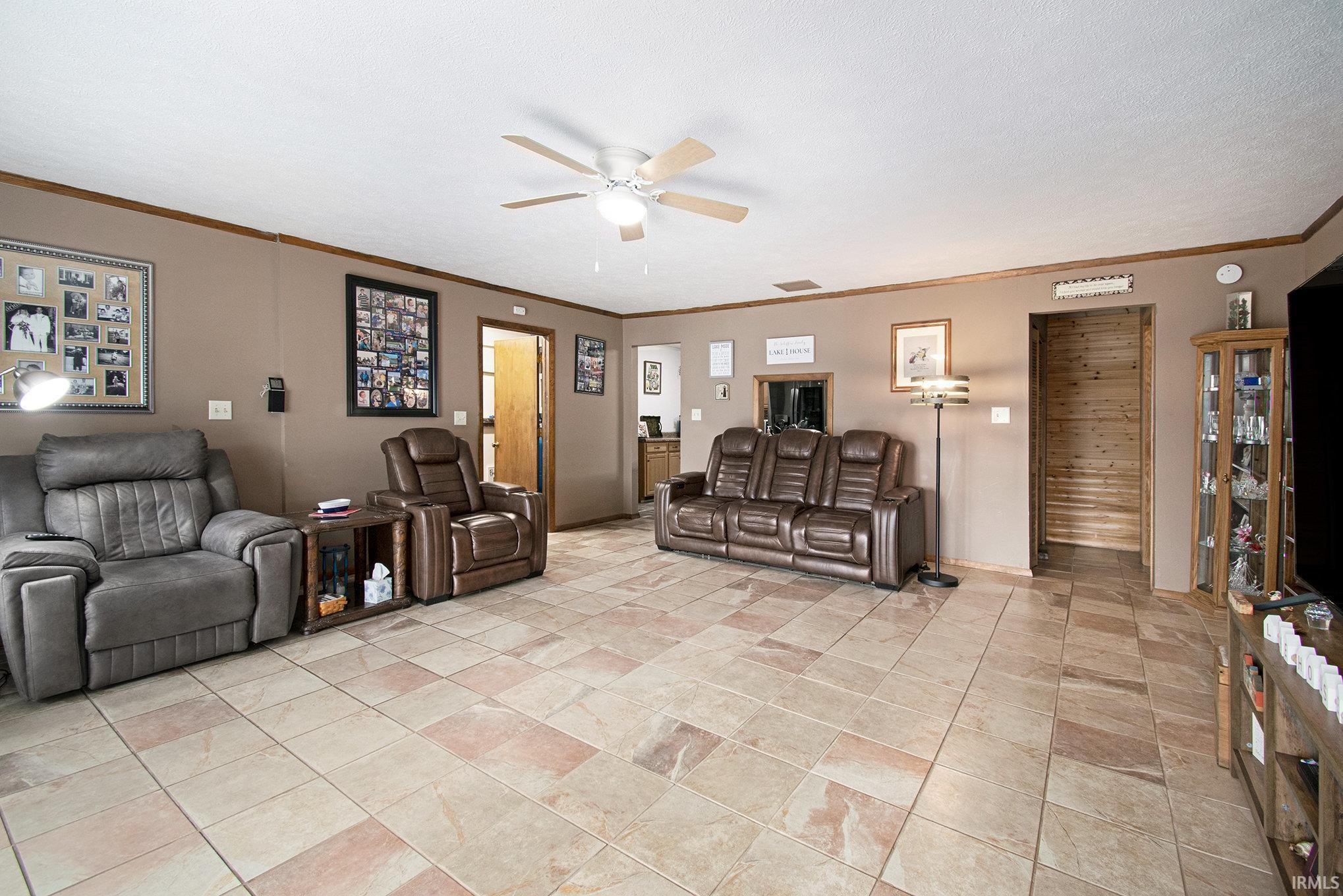 Image 3: Living area featuring a ceiling fan and ornamental molding, Living Room