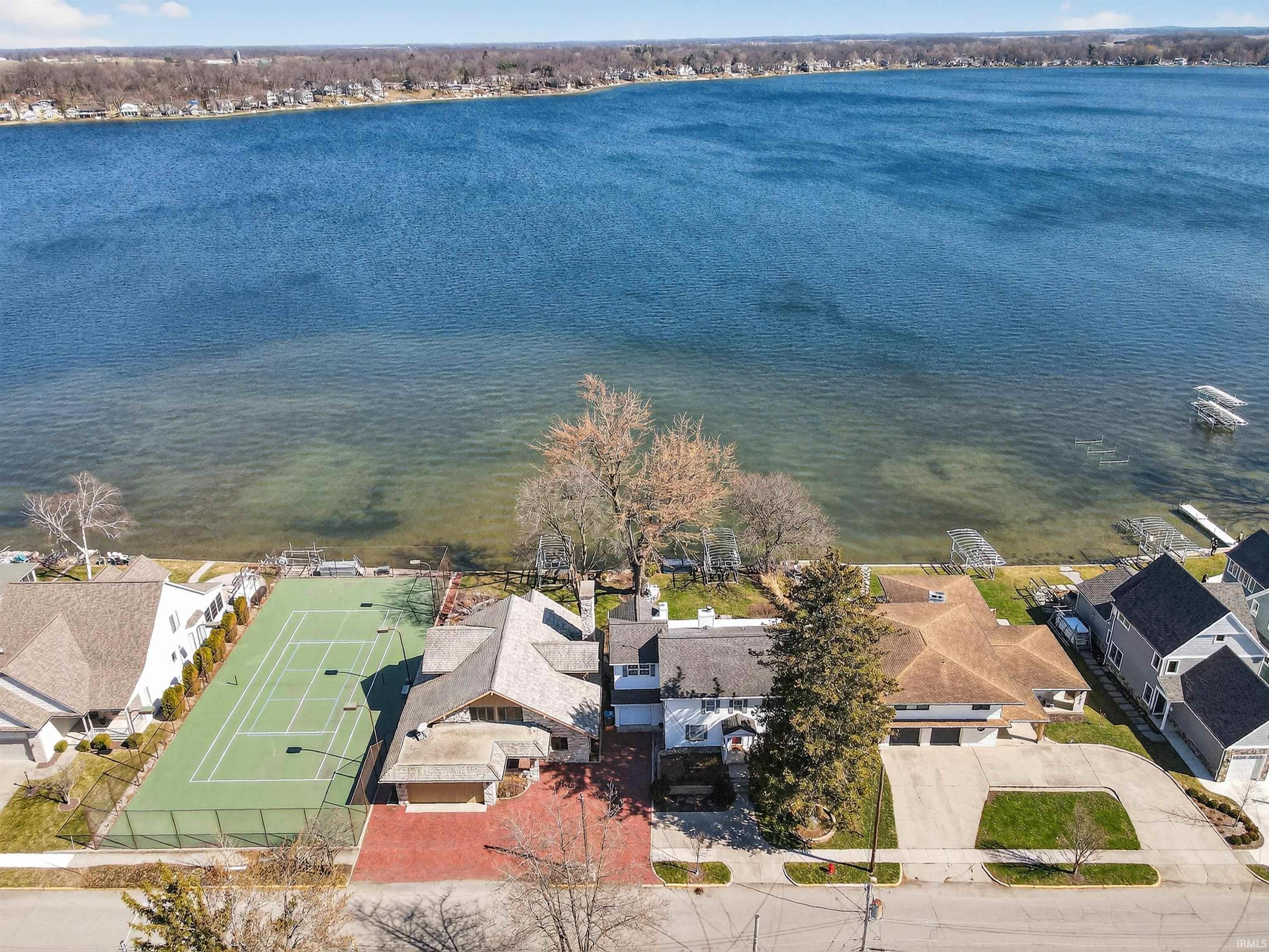 Image 2: Aerial perspective of suburban area featuring a nearby body of water, Aerial View