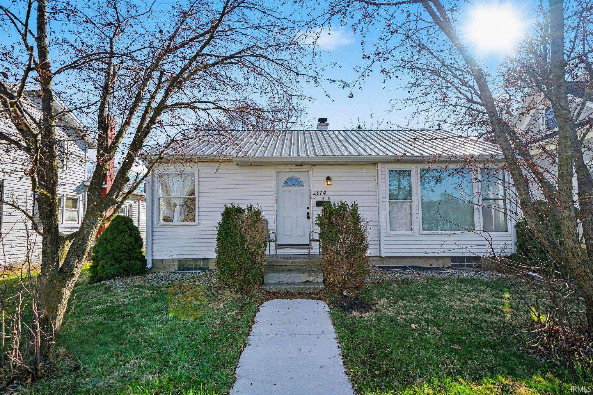 Image 0: View of front facade featuring a metal roof and a front lawn, Front Of Structure