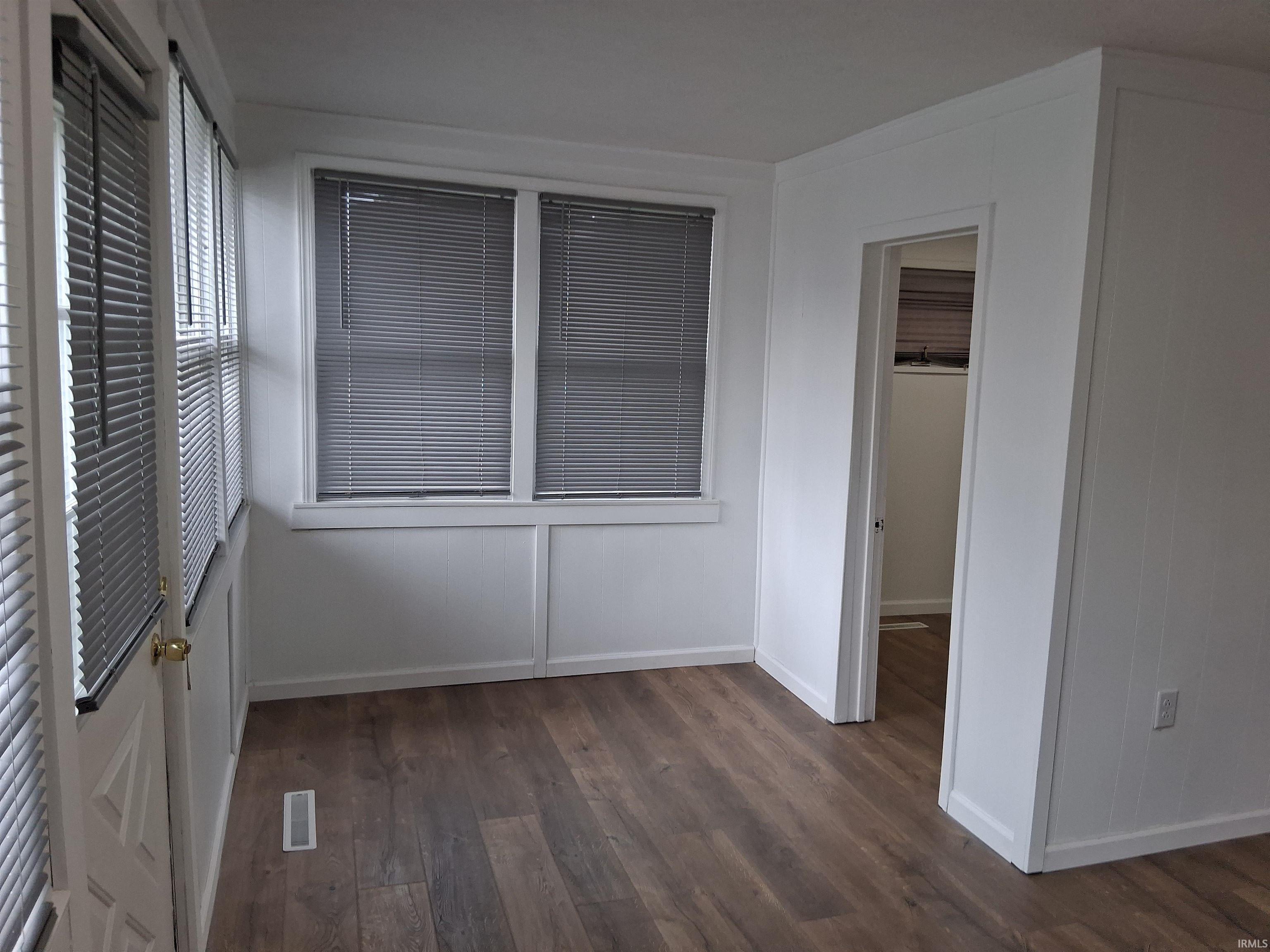 Image 3: Unfurnished bedroom with dark wood-type flooring and a spacious closet, Bedroom Image 3: Unfurnished bedroom with dark wood-type flooring and a spacious closet, Bedroom