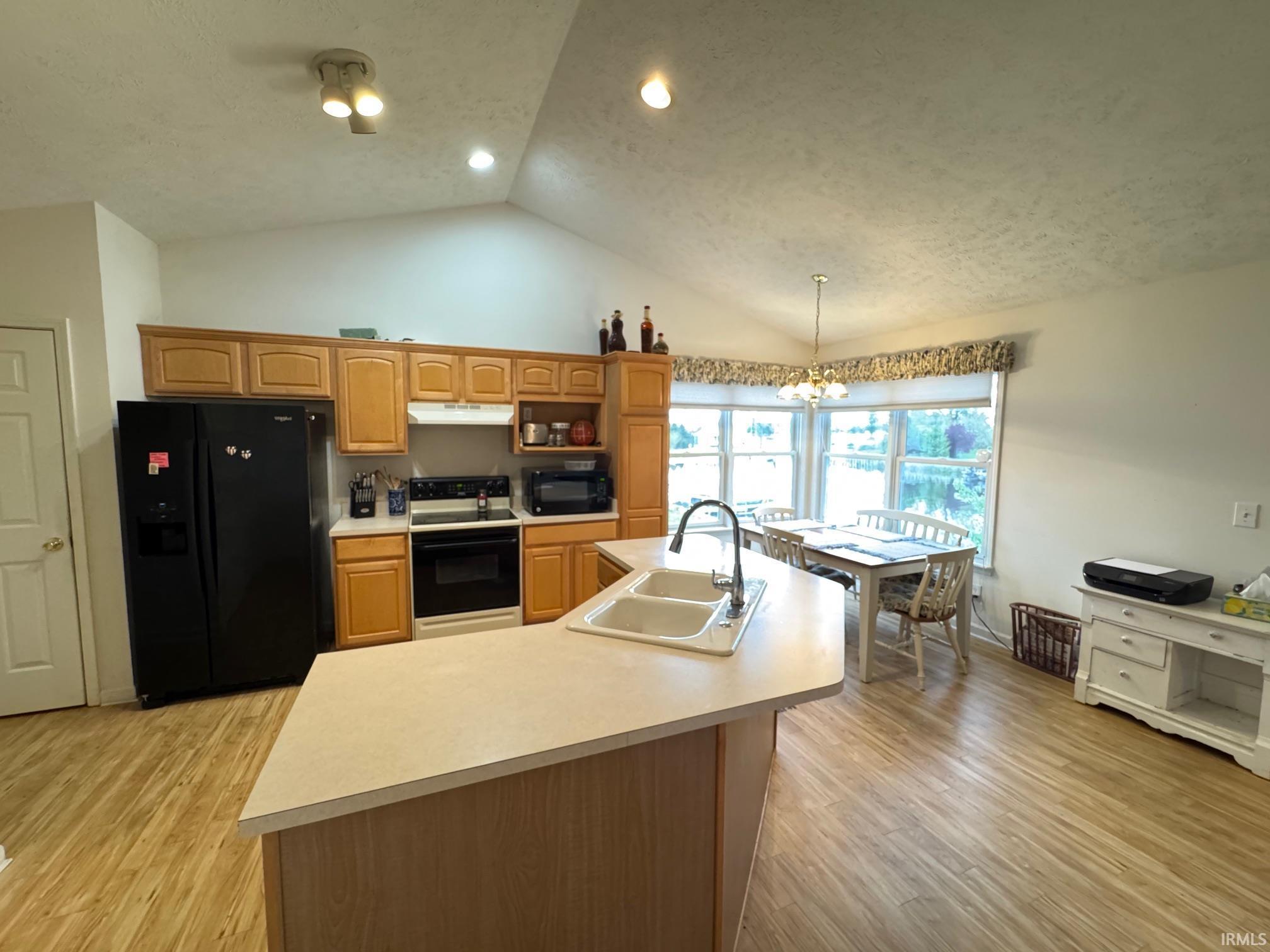 Image 1: Kitchen featuring vaulted ceilings with recessed and track lighting, Kitchen