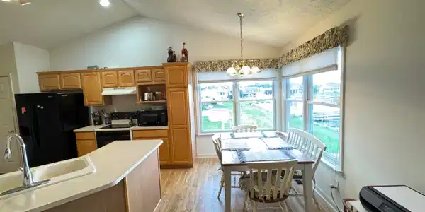 Image 2: Kitchen and dining area featuring a vaulted ceiling with recessed lighting, Kitchen Image 2: Kitchen and dining area featuring a vaulted ceiling with recessed lighting, Kitchen