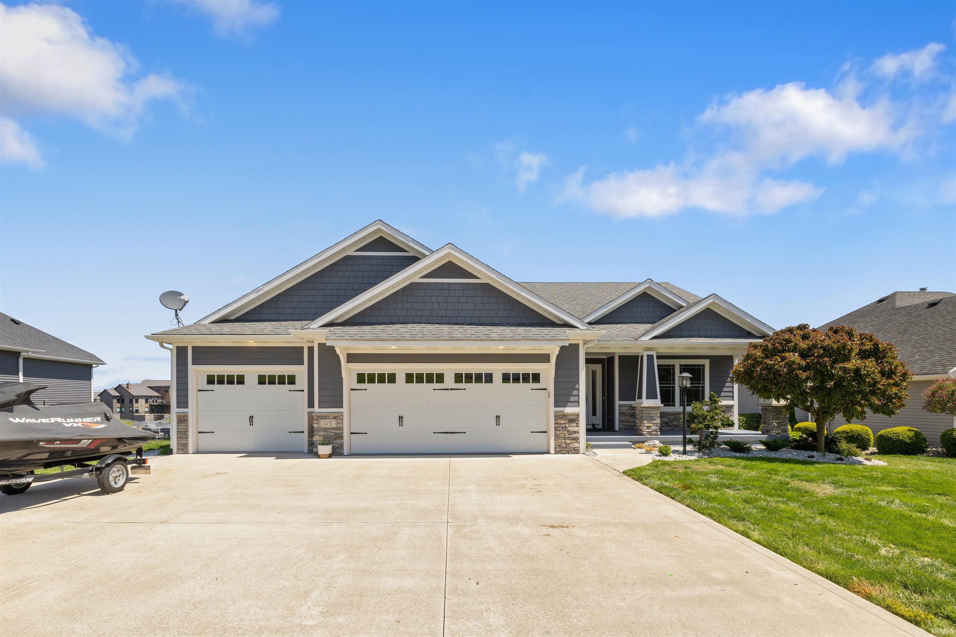 Image 0: Ranch-style residence featuring a multi-gable roofline, gray siding with shake accents, and stone veneer detailing, Front Of Structure Image 0: Ranch-style residence featuring a multi-gable roofline, gray siding with shake accents, and stone veneer detailing, Front Of Structure