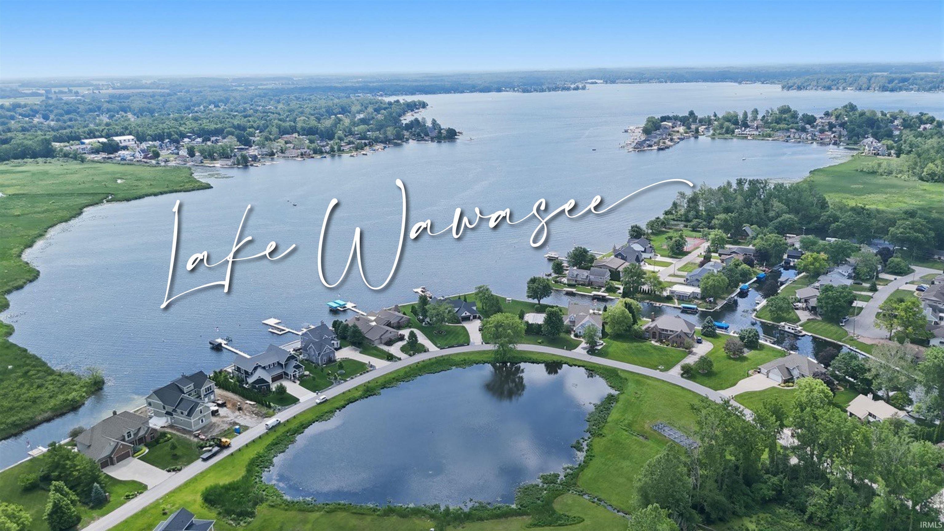 Image 1: Aerial perspective showcasing a residential development situated along a significant body of water, Aerial View