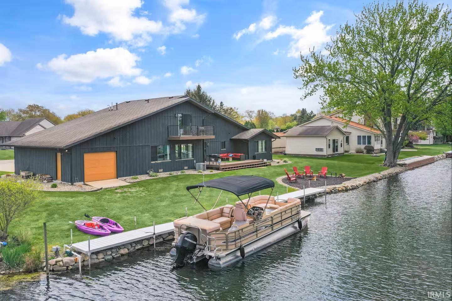 Image 2: Waterfront property featuring a dark-paneled exterior, a two-story layout, and a private dock, Back Of Structure Image 2: Waterfront property featuring a dark-paneled exterior, a two-story layout, and a private dock, Back Of Structure