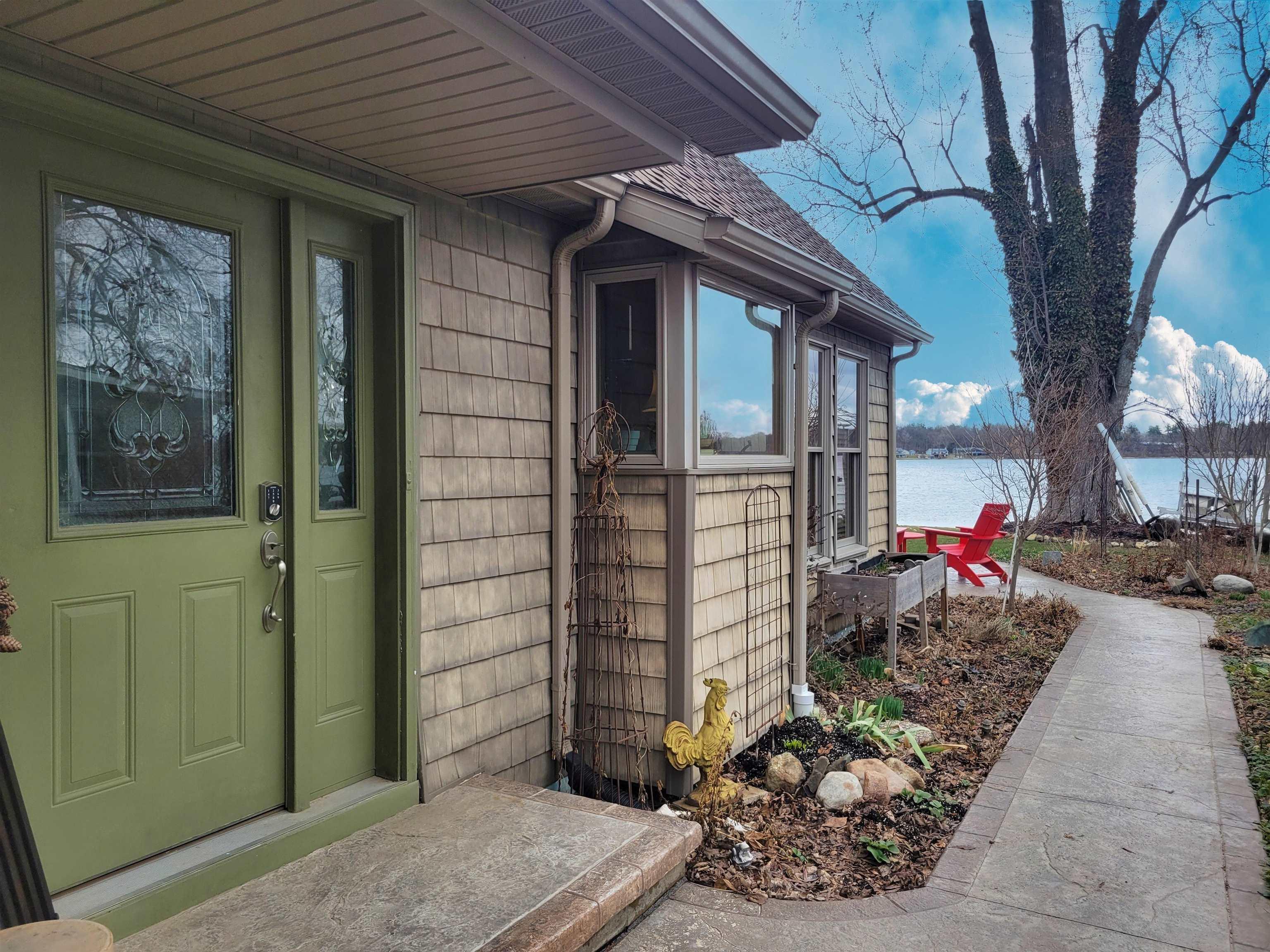 Image 3: Doorway to property with a shingled roof and a water view, Entry