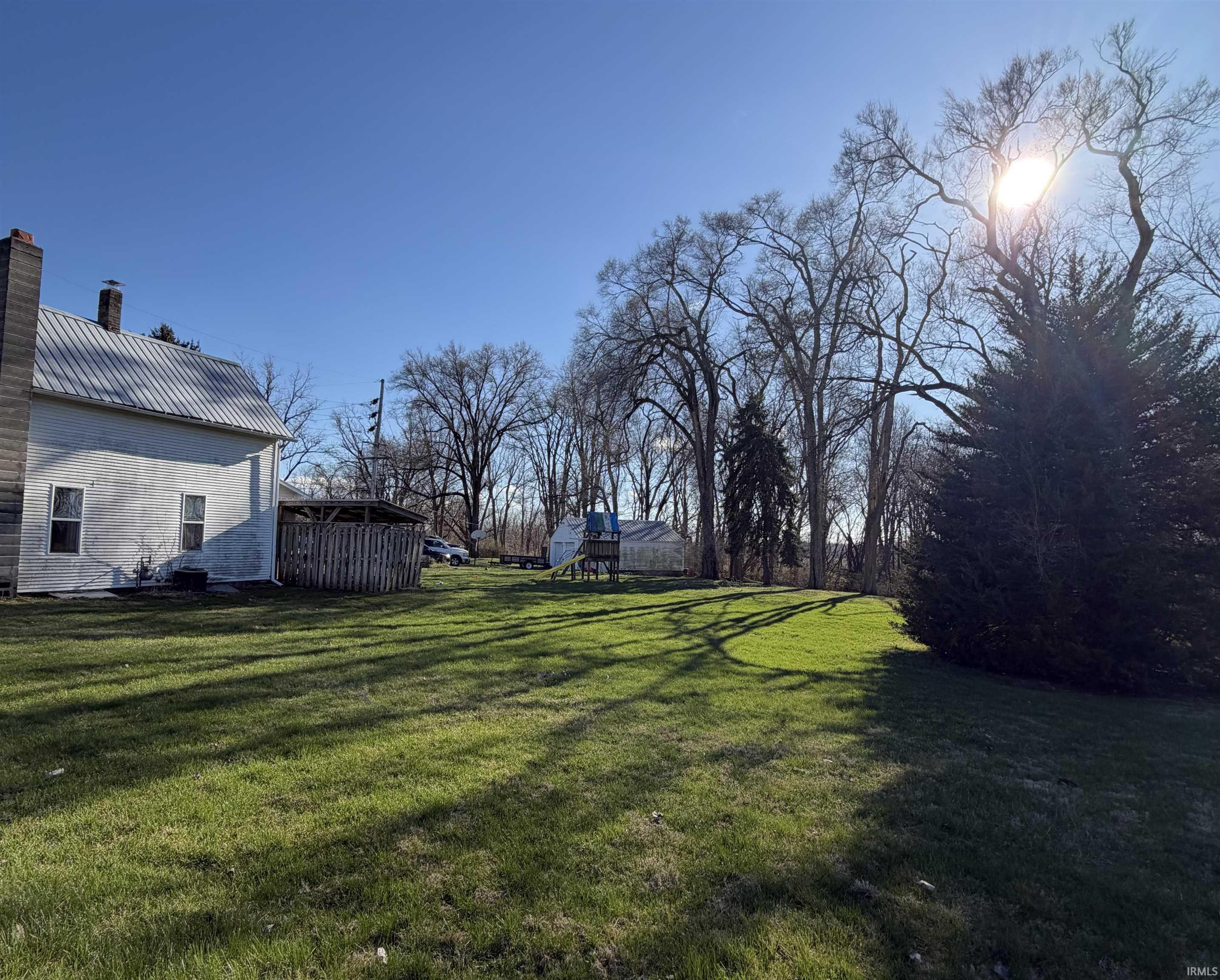 Image 3: View of green lawn with a playground, Yard