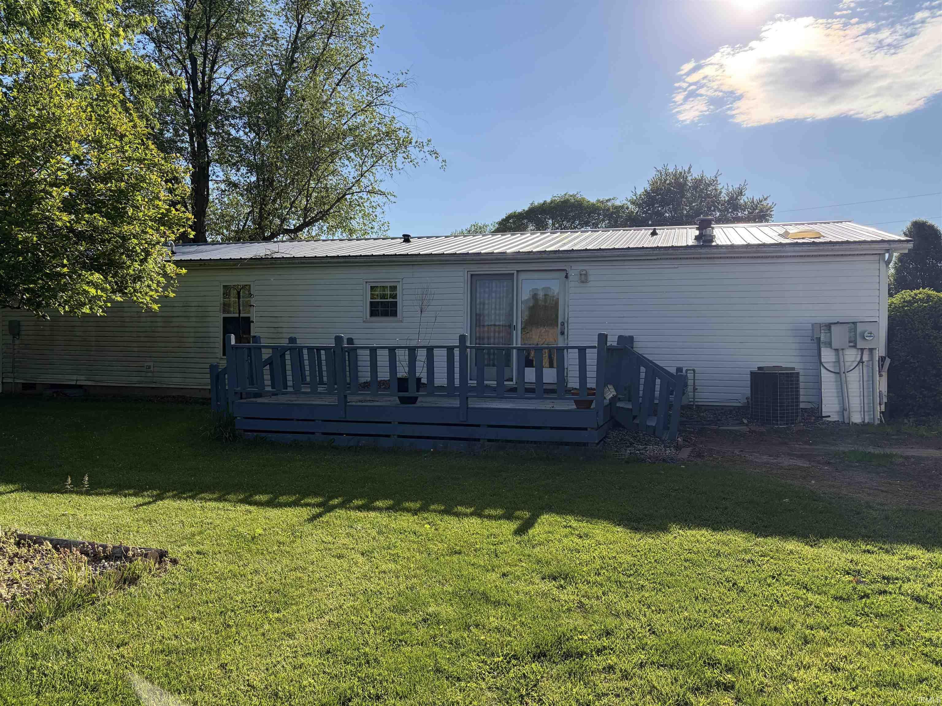 Image 2: Rear exterior featuring a spacious deck with perimeter railing, Back Of Structure
